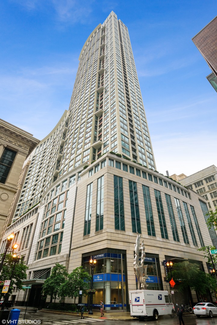 Don't miss this spacious 3-bedroom, 2.5-bath condo on the 30th floor of one of the Chicago Loop's most luxurious buildings! Floor-to-ceiling windows flood the home with eastern light and showcase sweeping views of Lake Michigan, Millennium Park, and Grant Park. The expansive living/dining room features hardwood floors and easily accommodates both a sectional sofa and full dining table. Step out to the private balcony-perfect for grilling or enjoying the sunrise over the lake. The kitchen boasts brand-new stainless steel appliances, abundant cabinetry, and granite countertops. The primary suite (currently used as a den) offers a professionally organized walk-in closet and a spa-style bath with whirlpool tub, separate shower, and dual vanity. Two additional bedrooms share a spacious second bath, plus there's a modern powder room for guests. A full-size, in-unit washer and dryer add everyday convenience. Heated indoor parking space (#710) is included. The Heritage is a full amenity building offering 24 hour door staff, on-site management, indoor pool, steam, sauna and hot tub, fitness room, party-conference room, 3 outdoor terraces, storage locker, bike storage, dog run and direct access to the Pedway.