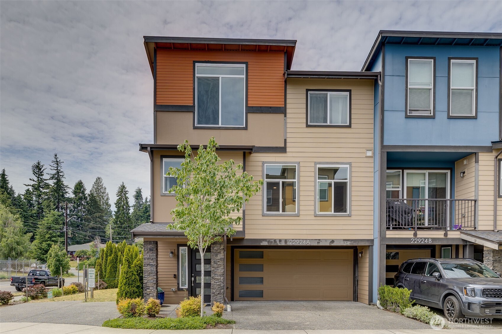 Spacious 4-bedroom end-unit with 3.5 baths and a 2-car garage. Filled with natural light, the open main level features a generous kitchen with a large center island, eating bar, dining space, built-in office nook, and an inviting living room with gas fireplace. Step outside to the covered deck for year-round outdoor living. Upstairs, the spacious primary suite features vaulted ceilings, oversized windows, a walk-in closet, and private ensuite, plus two additional bedrooms, a full bath, and conveniently located laundry. The lower level offers a private fourth bedroom and bath—ideal for guests, a home office, gym, or media room. Enjoy abundant storage, nearby guest parking, and exceptional access to everything Edmonds has to offer—just minutes from Downtown Edmonds, the waterfront, parks, shopping, dining, and light rail.