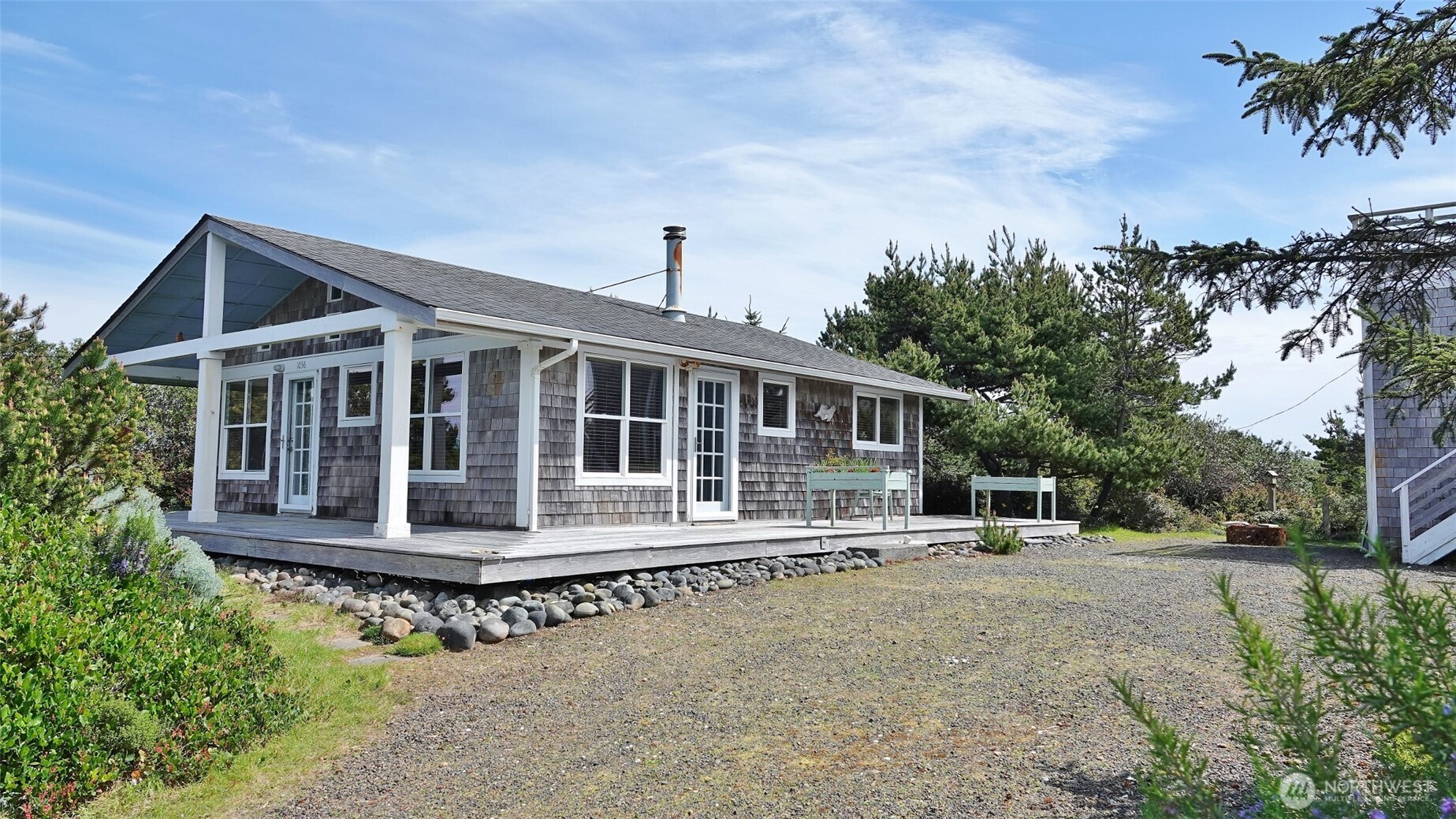 INCREDIBLE PRICE and DESIGNER STYLE featured in this cute home near the BEACH with 2 LOTS! Enter into this home with the unique vaulted wood ceilings and beams giving this home a designer touch of style. Parquet flooring in this Open Great Room design with wood-burning Fireplace. Kitchen with an Eating Bar and Granite tile counters. 2 nicely-sized Bedrooms, and a Full Bathroom with a washer and dryer. Enjoy the outside on the huge side Deck and Covered Front Deck. Lots of privacy provided by the natural landscaping surrounding this home and corner property. Approx. 120 sq.ft. Shed with very high ceilings and a Viewing Tower on top, which does offer some distant Ocean Views. Fenced Garden Area. BONUS: Spread out with the extra land space with the lot next door (1057 Crestshire Lp) included in the sale, giving this property approx. 15,800 sq.ft. of land.