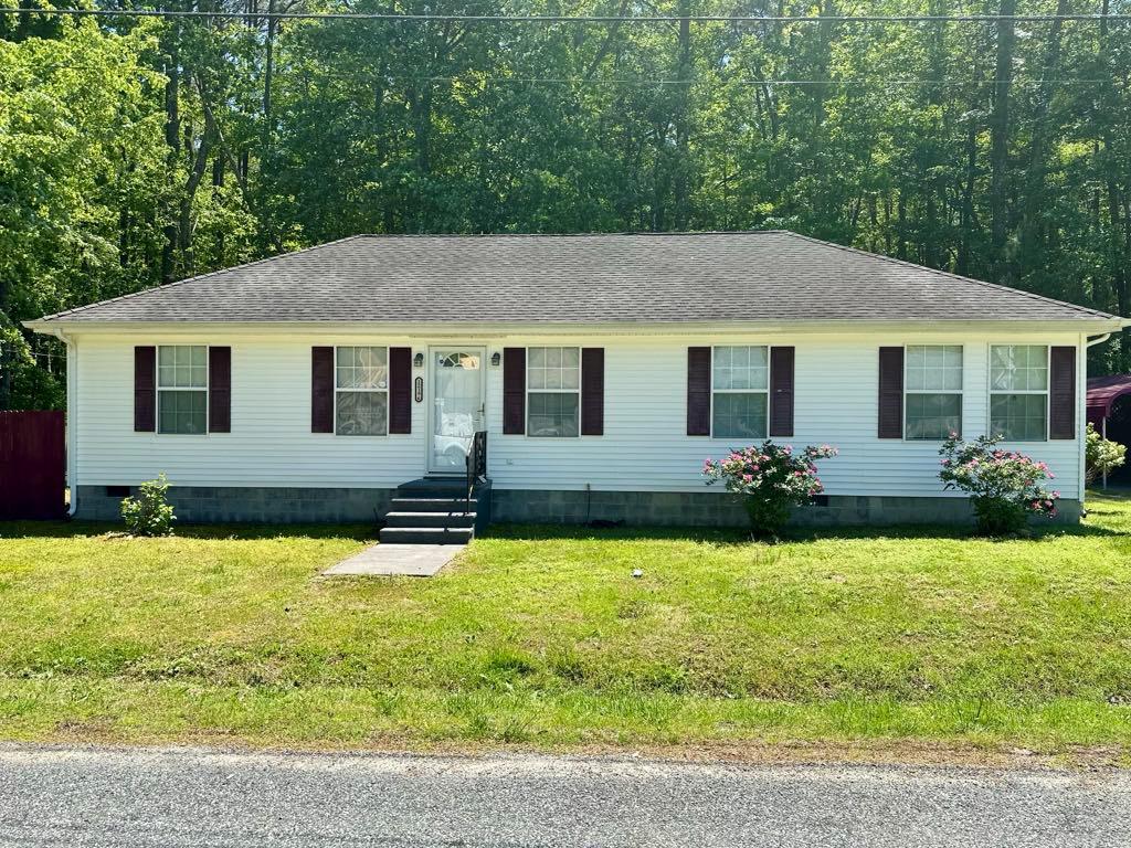 Welcome to this delightful 2-bedroom home that offers a perfect blend of comfort and functionality. Nestled on a quiet, private street, this property features two carports and a detached garage, providing ample parking and storage options. The fenced-in backyard is ideal for pets, gardening, or entertaining, the recently connected town septic system ensures worry-free maintenance. Enjoy sun-soaked living spaces with a bright and inviting sun porch that opens to a back deck, perfect for relaxing or hosting gatherings. With its convenient one-level layout, this home offers easy, accessible living. Don't miss your chance to make this charming property your own—call your agent today to schedule a showing!