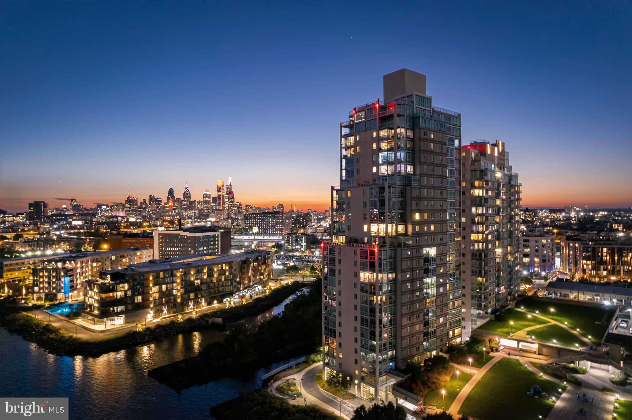 *UNIT SPECIFIC PHOTOS COMING SOON* Offered on the resale market for the first time, this rarely available residence at Waterfront Square includes two parking licenses and a same-floor storage unit!  From the moment you enter P1601, the home welcomes you with a sense of light, scale, and refined elegance. The foyer introduces the residence with brand-new 24-inch by 24-inch bright white polished Calacatta porcelain tile, extending seamlessly through the foyer, kitchen, and powder room. The large-format tile creates a sophisticated first impression while offering durability and easy maintenance. A double coat closet is conveniently positioned near the entry, while the powder room continues the home’s clean and elegant design.The home opens to an expansive living and dining space where ten-foot ceilings and dramatic floor-to-ceiling windows frame commanding views of the Delaware River and the iconic Ben Franklin Bridge. Natural light fills the residence throughout the day, enhancing the open layout designed for both comfortable daily living and effortless entertaining. The living room, dining area, and den feature brand-new wide-plank oak luxury vinyl flooring, offering the warmth and character of natural wood with exceptional durability. Beneath the flooring, acoustic underlayment has been installed to help minimize sound transfer, contributing to a quieter and more comfortable living environment.Custom lighting enhances the living spaces, including a crystal chandelier suspended above the dining area, creating an elegant focal point for gatherings. Additional custom lighting throughout the living room and den adds warmth and ambiance while complementing the residence’s refined aesthetic.The kitchen is truly a chef’s dream, beautifully appointed with granite countertops, a custom glass tile backsplash, stainless steel appliances, and classic white shaker cabinetry offering both style and functionality. The polished Calacatta porcelain tile flooring continues throughout the kitchen, maintaining the home’s cohesive design while providing durability for everyday living.Just beyond the kitchen, the den offers versatile living space ideal for a media room, home office, or additional lounge area.A discreet door off the main living space leads to the home’s private bedroom wing, thoughtfully separating the sleeping quarters from the entertaining areas and creating a quiet retreat within the residence.Each of the three bedrooms offers comfortable proportions and its own unique vantage point. The primary suite serves as a tranquil sanctuary, featuring river views, a spacious walk-in closet, and a beautifully renovated four-piece en-suite bathroom with custom tilework and a large jetted soaking tub. Bedrooms two and three are equally well positioned and are complemented by two full bathrooms located directly across the hall, providing convenient private access for guests or family.Step outside onto the private balcony, where the river, skyline, and bridge come together in a dramatic panoramic backdrop—an ideal setting to enjoy morning coffee or unwind in the evening while taking in the waterfront views.Completing the home are two premium parking licenses and same floor storage unit, adding convenience and ease to daily living.Waterfront Square Condominium & Spa is Philadelphia’s premier gated waterfront community offering 24/7 guard and gate security and concierge services. Residents enjoy resort-style amenities including an indoor pool and hot tub with river deck, a fully equipped fitness center, sauna and steam rooms, massage suites, and community lounges. The three-level garage supports Philadelphia’s largest green roof, while landscaped gardens stretch across 9.5 acres of beautifully maintained riverfront grounds. On-site management and an advanced closed-circuit security system provide peace of mind, and Global Limousine shuttle service offers weekday transportation to and from 30th Street Station.