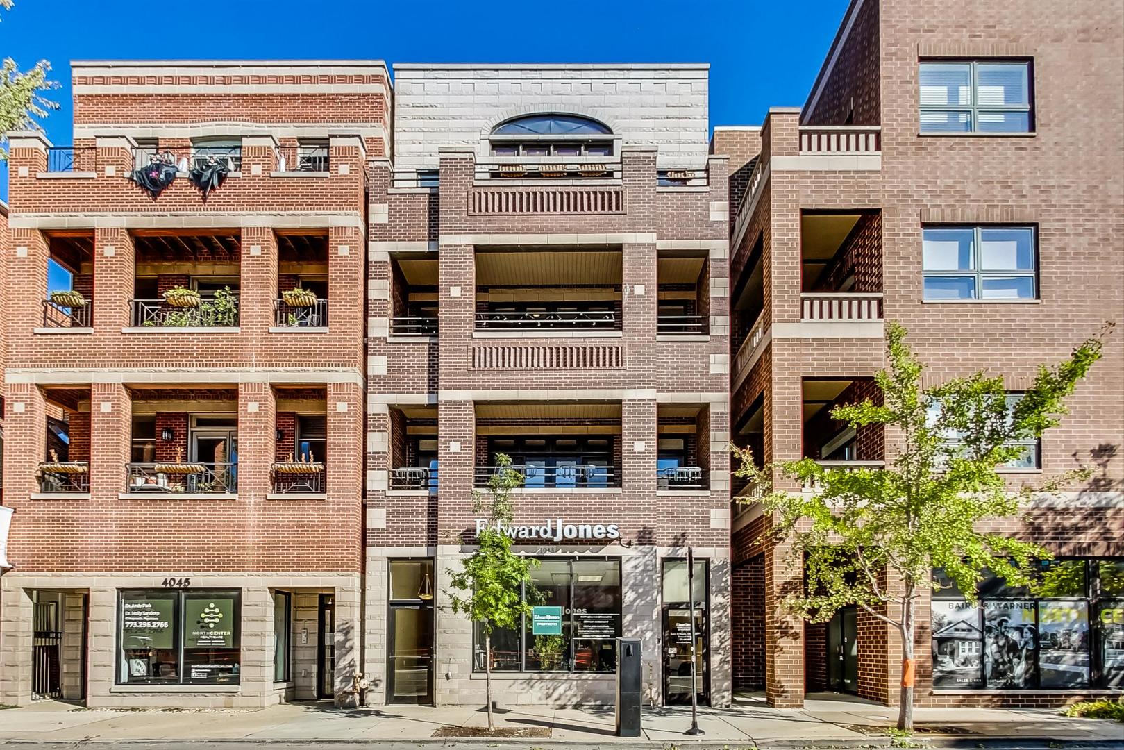 Step into elevated city living in this stunning third-floor condo, perfectly positioned in North Center's dynamic core. Sunlight pours through expansive west-facing french doors, illuminating a seamless layout designed for both comfort and style. The sleek kitchen is a true centerpiece, featuring high-end stainless appliances, a marble-topped island with ample storage, custom 42" cabinetry, and a built-in wine fridge. The living and dining spaces flow effortlessly, anchored by a chic updated marble fireplace and wired for surround sound-ideal for cozy nights or lively gatherings. A large covered balcony extends your living space outdoors, perfect for relaxing and unwinding. The serene primary suite is a private retreat with its own deck, walk-in closet with custom storage, and room for a full king setup. Indulge in a spa-worthy bath with steam shower, dual sinks, and jetted soaking tub. Two additional bedrooms offer flexibility for guests, office, or home gym, and share a beautifully finished second bath. All set in a coveted location near the Brown Line, and within the top-ranked Coonley School District. Don't miss your chance at owning this rarely available home!