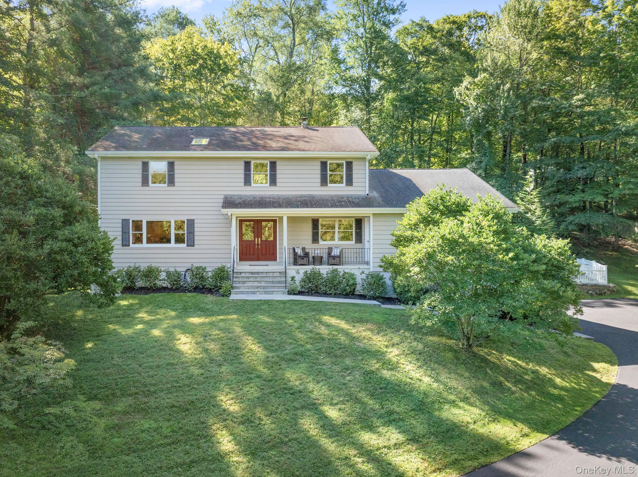 Timeless elegance meets modern comfort in this beautifully updated Colonial home.  Double entry front doors open to a gracious foyer, setting the stage for the home’s expansive and light-filled layout. At its center, the renovated chef’s kitchen impresses with gleaming Caesarstone countertops, professional-grade stainless steel appliances, dual dishwashers, an oversized island with prep sink, ample counter seating, and abundant pantry and cabinet storage. Designed as the true heart of the home, the kitchen flows into a sun-drenched four-season sunroom—an inviting space for casual dining, quiet reading, or relaxed evenings. Off the kitchen is an elegant dining room and spacious living room perfect for grand entertaining and everyday comfort. An elegant powder room and home office add refinement and functionality. Thoughtfully connected to the main living areas, a bedroom with full bath, family room, and sitting room provide flexible space for everyday living, while a separate entrance offers the option of a private guest or in-law suite. Upstairs, the large primary suite is a luxurious sanctuary, featuring an expansive walk-in closet and a spa-like full bathroom with large glass shower. Two additional bedrooms share a well-appointed full bath with bathtub. An upstairs laundry area provides convenience at your fingertips.
The lower level offers exceptional versatility, with generous storage, a secondary laundry room, and access to the oversized garage—large enough to accommodate three vehicles. Two attics provide additional storage solutions.
Outdoors, a spacious deck with an electric awning overlooks the level, fenced-in backyard. The entire house is framed by mature trees, professional landscaping, and vibrant plantings. Additional amenities include a full-house generator, basketball hoop and an enviable location close to schools, train, shops, parks, and with direct access to the North County Trailway.
This turnkey Colonial combines classic sophistication, modern amenities, and a welcoming floor plan—perfectly suited for today’s lifestyle and ready to be cherished by its next owners.
