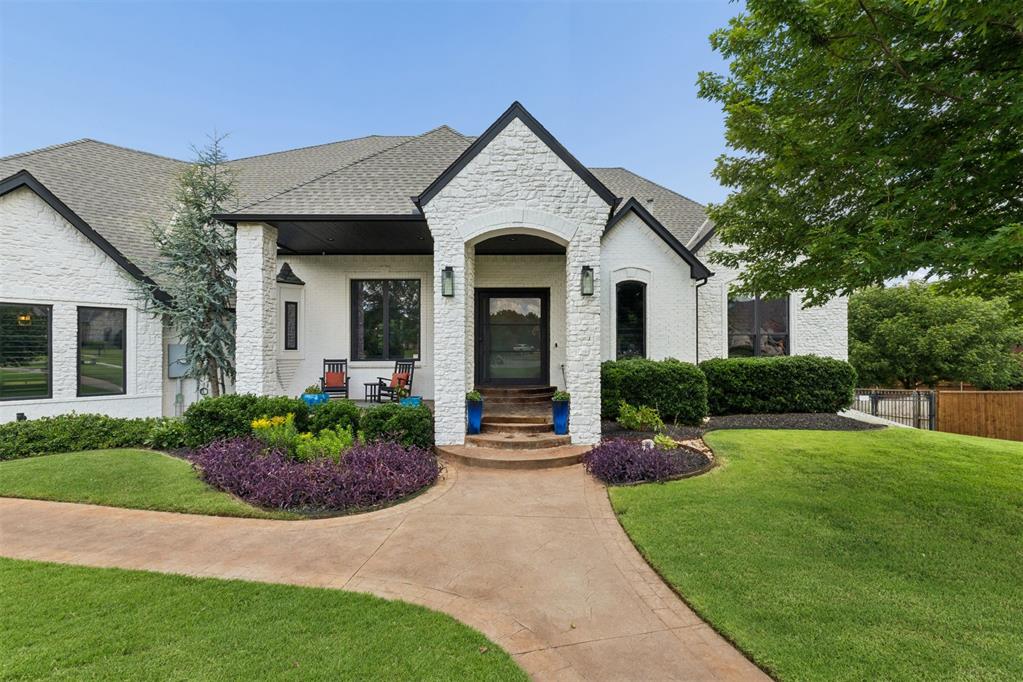 Welcome to 4317 Slate Bridge Road. This exceptional walk-out basement home captures water views from nearly every main living space on almost a half-acre. Introduced through a dramatic iron pivot door, the interiors are defined by soaring ceilings, expansive windows, rich hardwoods, and custom millwork. The great room features a floor-to-ceiling stone fireplace with a custom built-in media center. The kitchen has been remodeled, and highlights include dual islands, professional 6-burner gas cooktop with pot filler, walk-in pantry, secondary pantry, and an impressive suite of appliances. Just off the kitchen is a light-filled dining space. The floor plan offers two spacious secondary bedrooms connected by a Jack-and-Jill bath on the main level, while the lower level expands the home's versatility with an oversized recreation room, second living area, dedicated office, and direct backyard access. A downstairs bedroom with full bath is defined by a curved wall of windows. The dedicated home theater features a professionally installed Bowers & Wilkins 7.1.2 Dolby Atmos surround sound system with built in speakers, and customizable Savant lighting. Wine storage, wine refrigerator, and ice maker complete the lower level. The primary suite offers patio access through double patio doors and water views. The primary bath features a soaking tub, dual-entry walk-through shower framed by arched openings, separate vanities with a dedicated makeup station, and a boutique-style closet. Extra highlights include a Savant whole-home automation system with 12 zones, including patios and garage, garage lift system, custom wall storage and cabinetry, a 240V/30A garage circuit, and generator-ready connection. The energy-efficient walk-out basement maintains more moderate temperatures even during Oklahoma’s hottest summer days, staying in the low-to-mid 70s even with the downstairs HVAC off. Neighborhood amenities include pool, clubhouse, splash pad, stocked private lake and sidewalks.