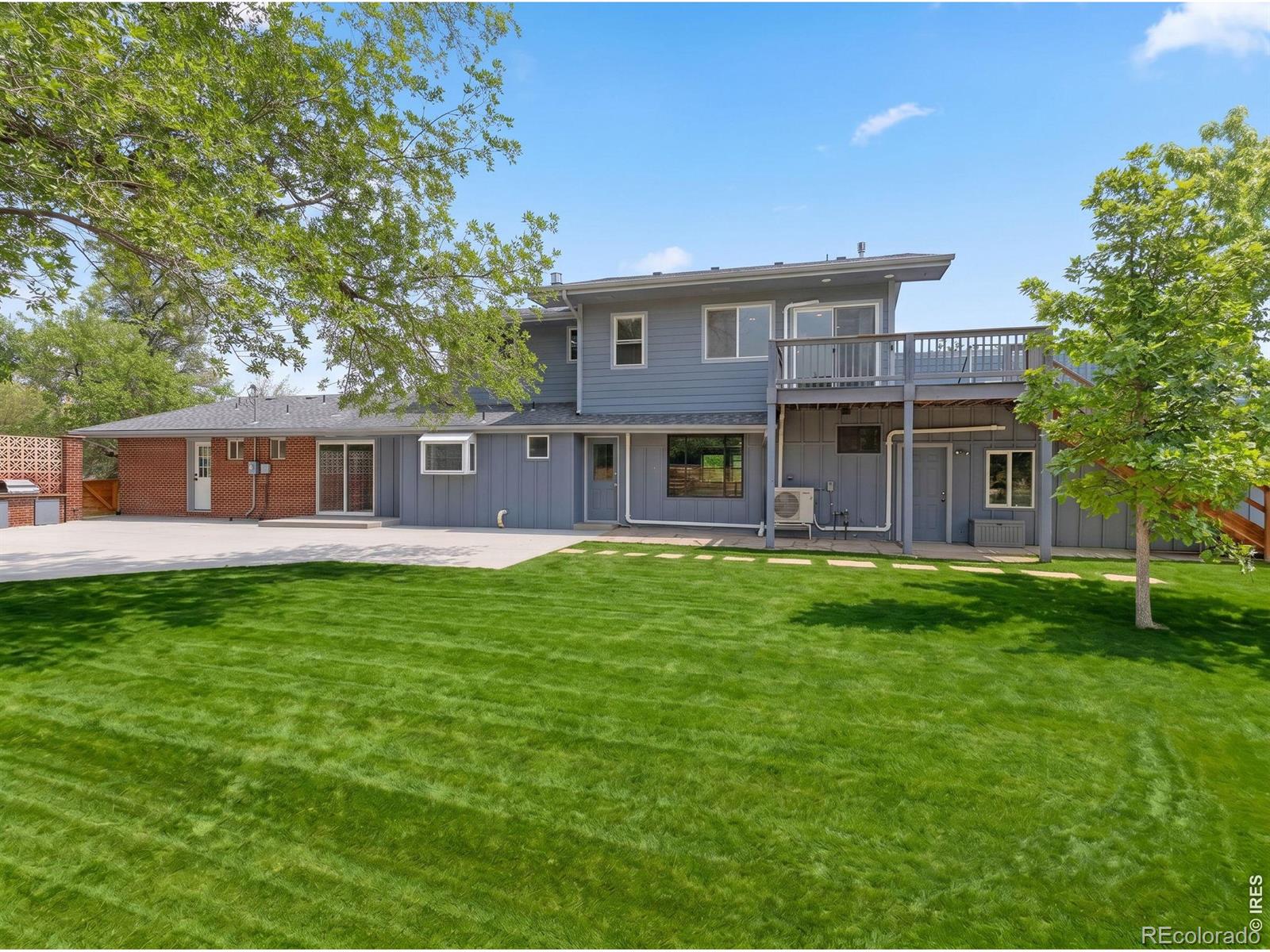 Expansive northeast Boulder home resting on a peaceful near-acre lot with Flatiron views in the charming Juhls neighborhood, with the freedom and flexibility of NO HOA. See for yourself the views and potential of this special home. This 4-bedroom + office, 5+ bath home spans 4,568 square feet across 3 levels, with a spacious main level, a private second-story primary suite, a versatile lower level, and both a family room and a rec room for everyday living and entertaining. Recent improvements, as the first phase of a permitted main-level renovation, include the new family room with a linear fireplace, built-in TV, and custom cabinetry, along with a nearly 800-square-ft attached garage with 10-ft ceilings fully insulated and climate-controlled. A practical mudroom off the garage adds a second W/D hookup, a custom dog bath, and a powder room. Other improvements include new flooring, a new water heater, and a ductless mini-split for the southern rooms, garage, and primary bedroom. Architectural plans and permits transfer to the new owner to continue this vision, or bring your own ideas; site plan review also allows for an expanded mezzanine and entryway, giving this special property the welcoming facade it deserves. The upper-level primary suite offers dual closets, radiant heat, a laundry room, a rooftop deck, and a separate entrance for an ADU or in-law potential. The lower level offers an additional bedroom, bath, large rec room, and plenty of storage. The private yard includes fruit and shade trees, and ample open space in the back for play, gardening, or livestock thanks to rural residential zoning. Recent updates include new perimeter fencing and gates, grading and irrigation in the small backyard, French drains and hardscaping. A separate storage shed keeps lawn equipment and outdoor toys tucked away. Enjoy lower sales and property taxes by living in Unincorporated Boulder County. Visit the open house Saturday, July 25th,11 am-1 pm