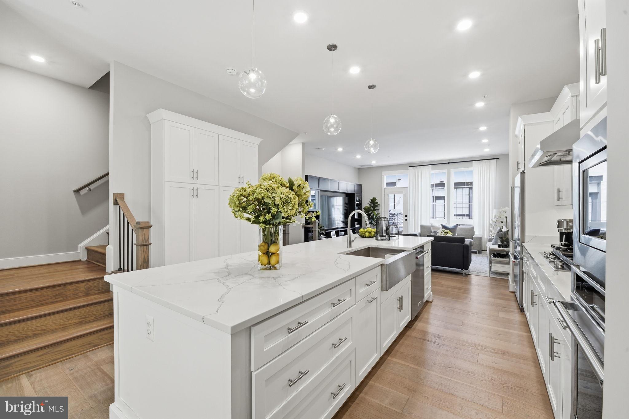 Welcome to the most connected destination in Reston. This sophisticated, four-level contemporary townhome offers a seamless blend of luxury and convenience, located just 1.5 blocks from the Silver Line Metro and the vibrant energy of Reston Station. From the moment you walk through the door, you’ll notice the exceptional quality, featuring 10-foot ceilings, wide-plank hardwood floors, and a floor plan designed for effortless flow. The main level is a entertainer's dream, anchored by a gourmet kitchen with premium finishes that opens into a sun-drenched living area. Whether you are hosting friends on the rooftop terrace or relaxing in the primary suite, every detail has been thoughtfully considered. Designed for the discerning buyer, the owners have maintained the home and it shows like NEW! This four-level home blends sophisticated architectural details with an open-concept layout perfect for modern life. Key Highlights:  Hardwood floors throughout, deck with gas line for grill, bathroom on every level. Gourmet Kitchen: Premium shaker cabinetry, oversized prep island with seating, and 6 burner gas stove. Designer Upgrades: Post-builder enhancements including Tesla charger, finished garage floor, window treatments, Container Store closets through-out. Flexible Living: Primary suite with dual walk-in closets, a private 4th-level loft with huge entertainment space, a bedroom & full bathroom, and an entry-level bedroom ideal for home office or gym use with attached full bath. Outdoor Oasis: Expansive rooftop terrace with space for eating and star gazing. Prime Location: Minutes from the W&OD Trail, Starbucks, Vida Fitness, Wiehle Metro, Reston Town Center, Dulles Airport, and major commuting hubs like Tysons Corner and DC. Enjoy the low HOA fees but still want the amenities? You have the option of applying for the amenities at the Faraday right across the courtyard. For $400/yr you have access to garage parking, gym, rooftop pool, dog wash area, game room and community room. This is going to be your favorite before you step foot in it! Welcome & Enjoy.