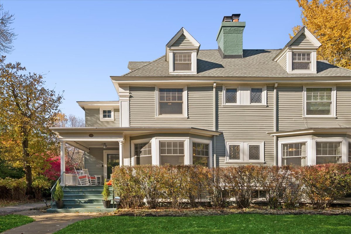 Beautifully updated 1896 Myron Hunt-designed double house, perfectly situated in one of Evanston's most desirable locations. Offering approximately 3,500 sq ft above grade plus an additional 1,000 sq ft walkout finished basement, this historic home blends architectural charm with modern comfort.  Set on an expansive 70x165 lot, the property features stunning landscaped gardens, a patio with pergola, brick paver driveway, raised garden beds, new perimeter fence, and a detached 2-car garage-a perfect outdoor retreat for entertaining or relaxing.  A gracious front porch leads to a welcoming foyer and a classic floor plan filled with natural light. The living room showcases large windows, custom sisal carpet, built-in bookcases, and a gas fireplace (new liner and firebox). The inviting family room addition offers a second fireplace, built-in bookcases and desk, and radiant heated floors, creating a warm, open-concept space for everyday living.  The fully renovated kitchen is a chef's dream, featuring radiant heated floors, quartzite counters and backsplash, exquisite tilework, custom cabinets, and a Bertazzoni induction range.  Upstairs, the second floor includes three bedrooms, two baths (both with radiant heated floors), and a convenient laundry closet. The primary suite offers custom closets and recessed lighting, plus a stylishly renovated primary bathroom. The third floor adds exceptional versatility with two additional bedrooms-each with semi-custom built-ins, mini-split systems, and an updated full bath featuring a newer shower, vanity, and door. The finished basement includes a family room, office/den/gym, full bath, second laundry room, and a large storage closet.  Additional highlights include new Marvin windows on the first and second floors (except one middle bedroom and the hall bath), and new windows on the third floor.  Enjoy a prime location-just four blocks from downtown Evanston-with easy access to Metra, Purple Line, restaurants, cafes, boutiques, gyms, and the vibrant cultural scene of the North Shore. For outdoor enthusiasts, the lakefront and running/bike path are just minutes away. Top-rated Evanston schools-from elementary through high school-are all within a few blocks.  A perfect blend of history, elegance, and modern living.  See the feature sheet for a complete list of updates.