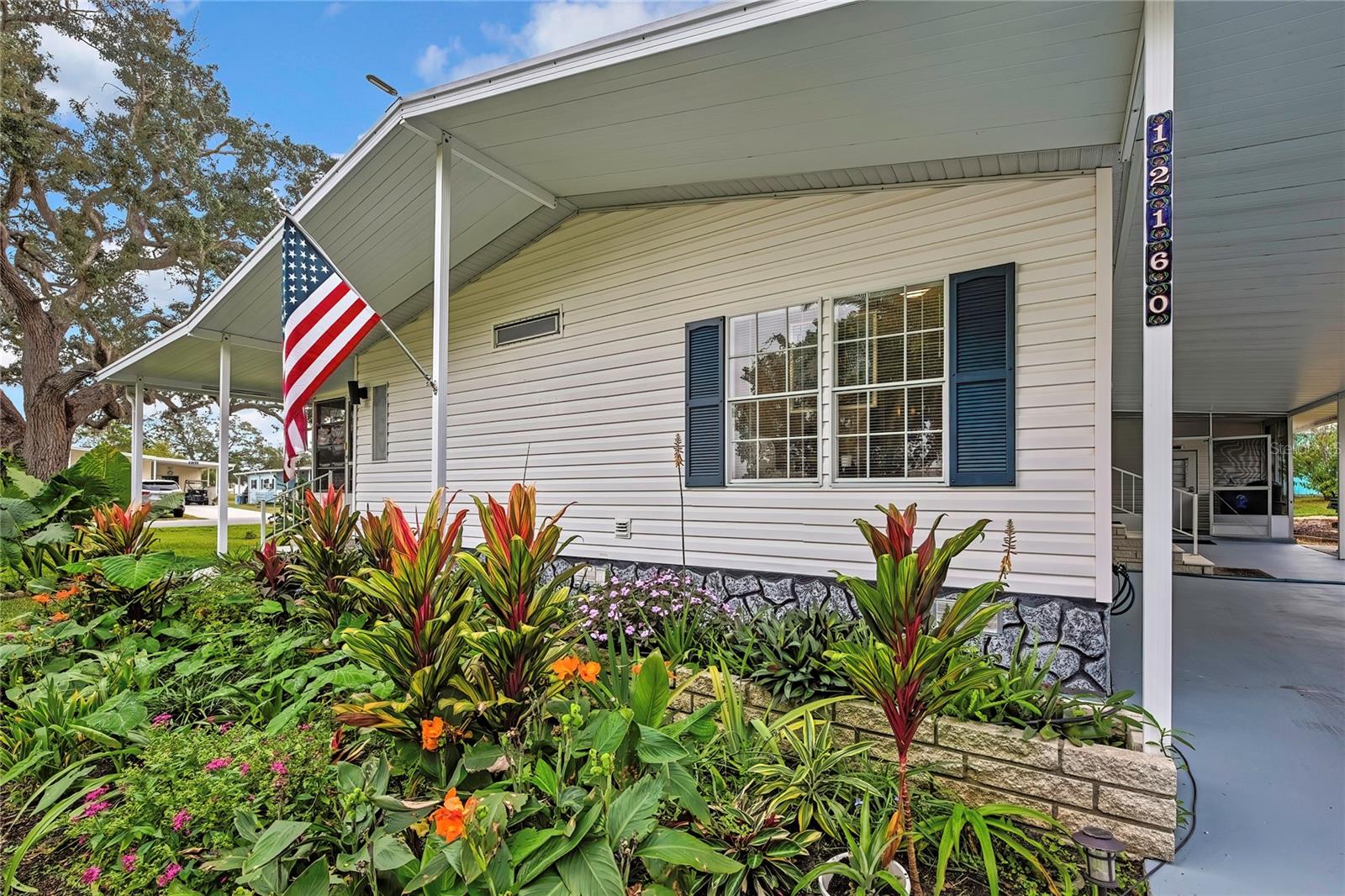 Welcome to this beautifully maintained 3-bedroom, 2-bath home perfectly situated on a spacious corner lot surrounded by lush, mature landscaping. Step inside to discover all-new life-proof flooring—scratch-resistant and waterproof—paired with new carpet in the bedrooms for ultimate comfort.  The spacious lanai is an inviting retreat featuring new vinyl windows, new carpet, charming fairy lights, and plenty of room to relax or entertain.  The kitchen features freshly painted cabinets, new faucet, a beautiful breakfast nook, coffee bar, new refrigerator —all creating a light, open, and welcoming atmosphere. The convenient inside laundry area adds to the home's functionality.  The primary suite offers a completely remodeled ensuite bath showcasing a jacuzzi tub, new tile flooring, modern vanity, updated fixtures, toilet, and a heated, lighted mirror. Two guest bedrooms are located on the opposite side of the home for added privacy and share a beautifully updated second bath featuring mosaic tile, walk in shower, new flooring, lighting, fixtures, vanity, and toilet.  Outside, the property includes a carport and golf cart garage with overhead storage rebuilt with new wood, plus an additional air-conditioned building with a window for natural light, cabinetry, and work tables—an ideal setup for an office, craft room, or hobby space.  Additional upgrades include a resealed lanai roof, 2021 TPO roof on the main home, 2021 the AC compressor was replaced, fully serviced, recharged and cleaned including ducts, freshly painted driveway, new plumbing, and new skylights filling the home with brightness and peace of mind.  This move-in-ready home comes complete with a golf cart and Hydrostatic Cub 33-inch riding mower, offering the perfect blend of comfort, convenience, and Florida charm.Come enjoy High Point 55+ Community where you OWN YOUR LAND and HOA is only 44.00 a month.Amenities include golf, pool, pickleball, clubhouse activities and so much more.  Schedule your showing today!