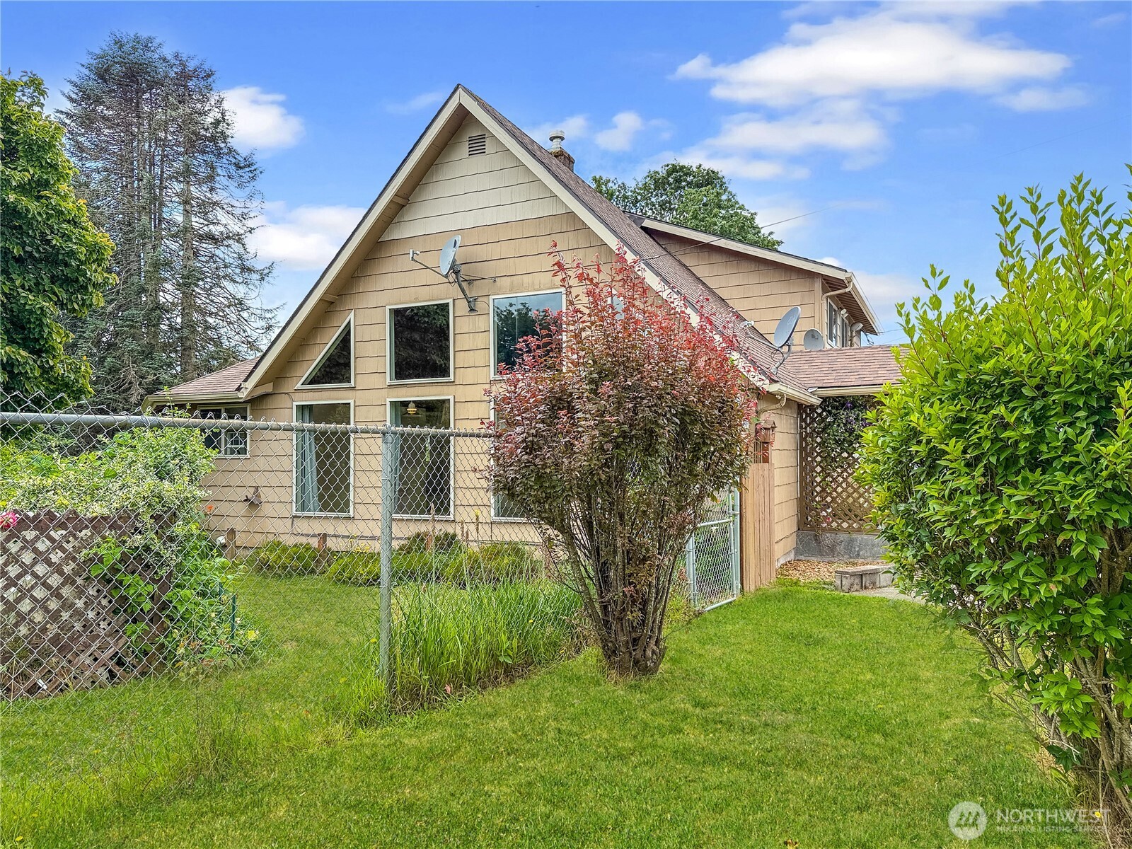 Tucked away on nearly an acre in the heart of Cathlamet, this charming 3 bedroom, 2 bathroom home offers space, character and unique features you won't find just anywhere. Vaulted ceilings and beautiful built-ins add warmth and style, while the open layout invites comfort and connection. Located on a quiet dead-end street, the property includes a massive shop with its own bathroom and fully equipped office - ideal for work from home, hobbies, or future projects. Step outside and you will discover decades-old fruit trees and mature landscaping. The outdoor features don't stop there: RV hookups, an attached garage, a historic logging camp building, and a separate studio with its own sauna make this home truly one-of-a-kind.