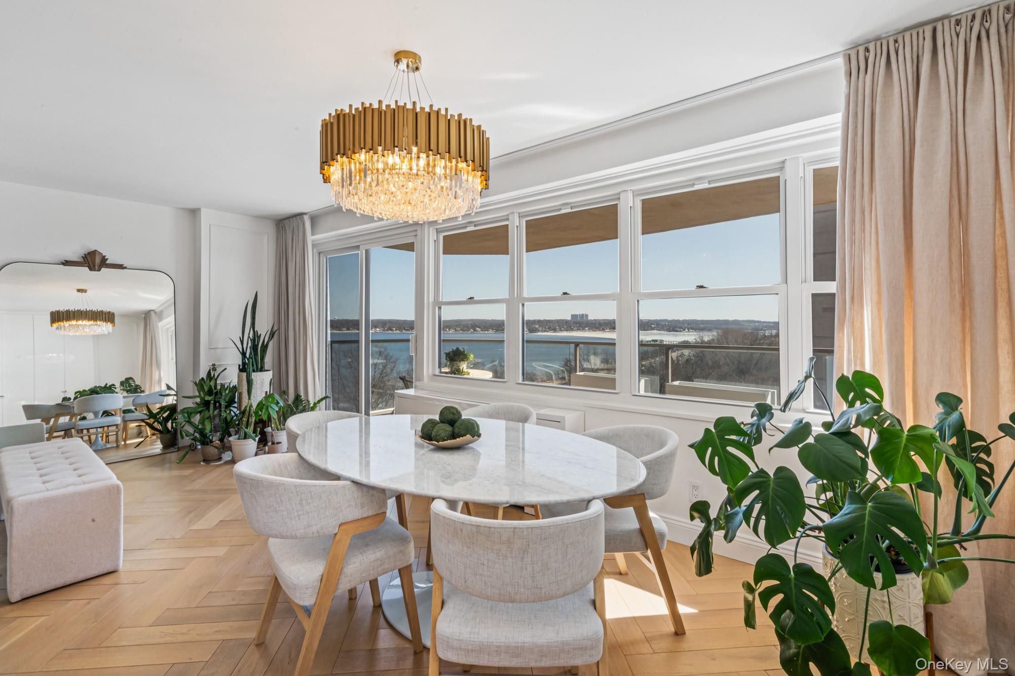 Designer Luxury top-floor residence located in the vibrant Bay Terrace area in the heart of Bayside, NY. This spectacular, fully gut renovated 3 bedroom, 2 full bath end unit apartment offers heated bathroom floors, smart Nest lighting controls, remote-controlled shades throughout and BREATHTAKING water views from every bedroom plus 2 private terraces with panoramic views overlooking the Long Island Sound. Designed for modern luxury living, the home features a stunning chef's kitchen with waterfall quartz countertops and matching quartz backsplash, custom cabinetry, gorgeous designer lighting and stainless steel top-of-the-line appliances. Both bathrooms showcase floating vanities, full porcelain tile throughout and high-end hardware. California Closets were professionally installed throughout, including two walk-in closets in addition to abundant additional closets in each bedroom as well as newly installed herringbone hardwood floors. The apartment is in absolute mint condition and offers exceptional natural light and panoramic views from every room. In addition, there are full-service building amenities including 24 hour doorman and security, valet parking for guests, on-site delicatessen, dry cleaning, beauty spa, laundry facilities, indoor garage and outdoor parking, outdoor heated swimming pool, brand new state of the art fitness center, tennis courts and Pickle Ball. Located in an excellent school district and close to shopping center, express bus service to Manhattan and easy access to the Long Island Railroad via NYCT bus which can also take you to Main Street for a quick Manhattan commute (under 30 minutes). A rare opportunity to own a turnkey luxury apartment with resort style amenities and unmatched views.