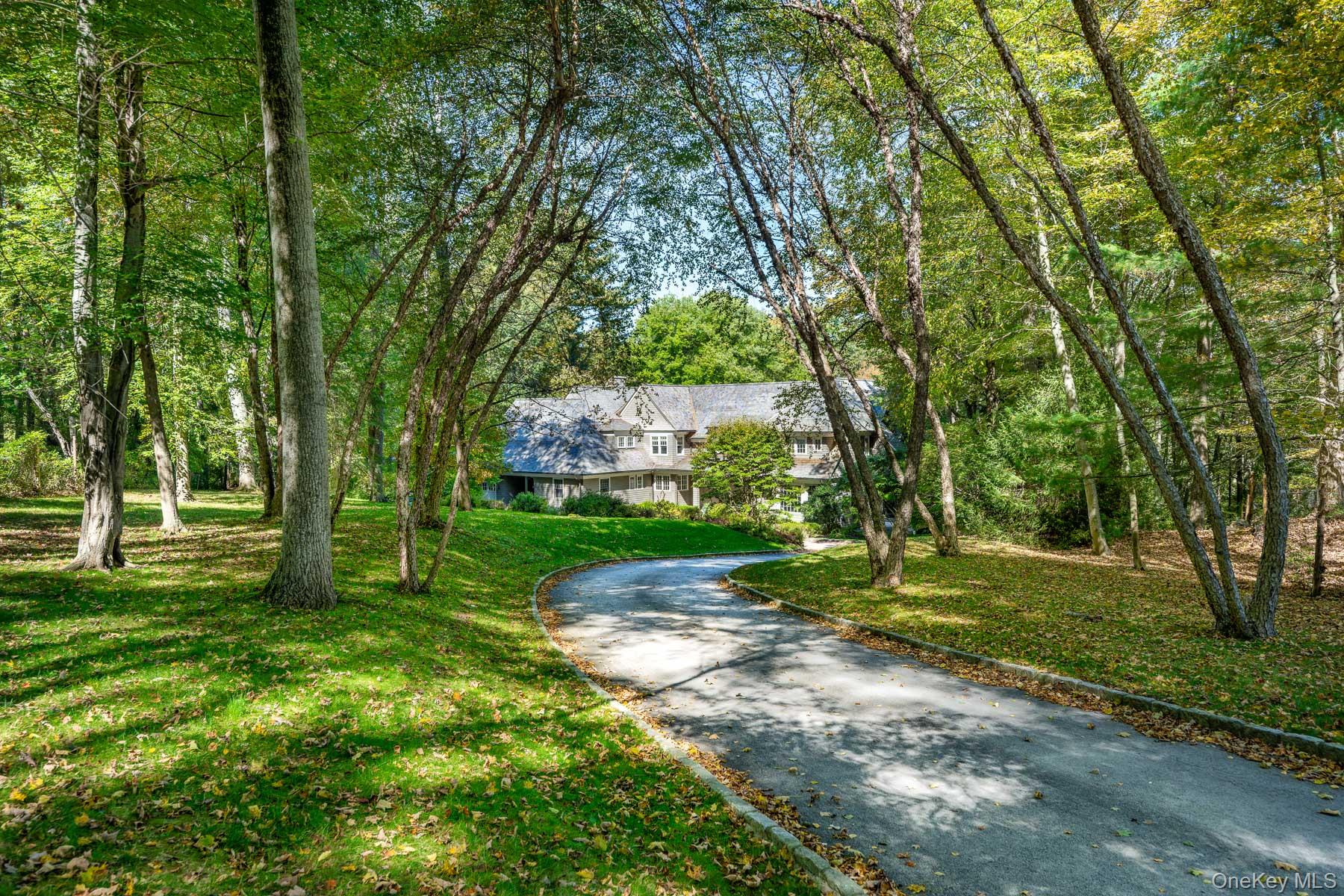 Welcome to 16 Millers Mill Rd, Bedford, NY, a custom-built, 5-bedroom, 5 1/2 bath home nestled on over 5 acres adjacent to the Mianus River. This American Shingle Style residence boasts 6,000 sq ft of living space with exceptional attention to detail and a layout designed for modern living. Professionally landscaped, the property naturally presents the home. 
The property is  situated on a quiet, designated scenic road, a stone's throw from the Mianus River Gorge and its expansive  network of walking trails. The home is also a short drive from the historical village of Bedford, known for its charming shops, restaurants, and arts Playhouse. 
The interior features a recently renovated kitchen with Quartzite countertops and top-of-the-line appliances. The family room, with a  fireplace, transitions seamlessly to a three-sided screened porch and a spacious flagstone terrace—ideal for entertaining. One of the five bedrooms, currently used as an art studio, is conveniently located on the first floor with its own bath.
The family and living room's fireplaces 'bookend' the house creating a gallery from end to end.  All  public rooms, the dining room, living room and office/library are graciously sized with detailed moldings. 
The second floor houses the primary suite with a coffered ceiling, two walk-in closets, and a luxurious bath with a heated floor.  Three additional bedrooms, two bathrooms, and a large bonus room complete this floor. 
The lower level provides a 'hang-out' room, a full bath, and access to the beautifully landscaped pool and spa. Additional features include a temperature-controlled wine cellar and ample storage. 
A chance  to experience the perfect blend of privacy, luxury, and convenience - a property which has never been offered for sale until now.