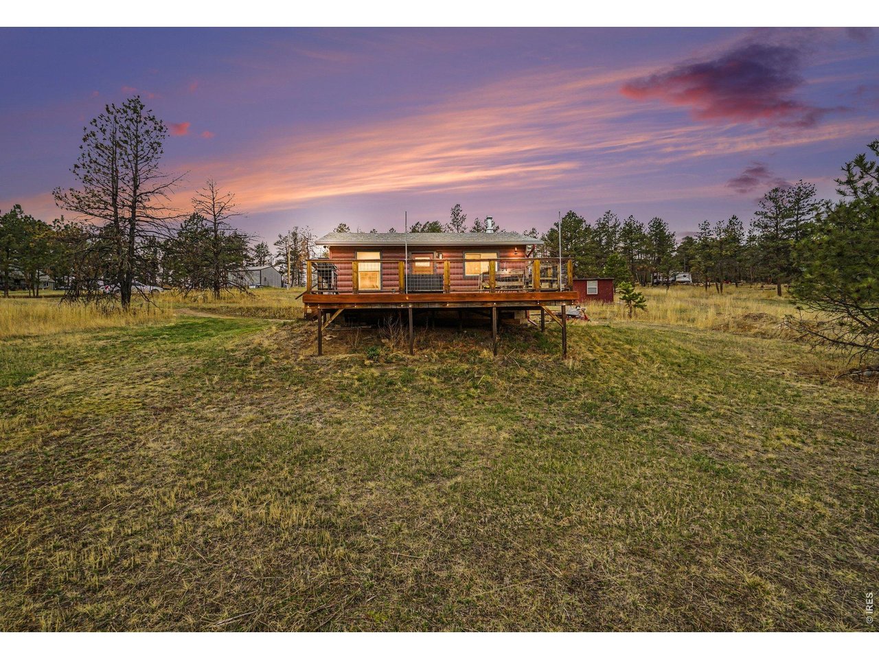 Tucked into the foothills at the base of Storm Mountain, this private mountain retreat offers a rare opportunity to experience Colorado in its most authentic and tranquil form. Set on 1.65 acres , the residence is perfectly positioned to capture sweeping alpine vistas and a true sense of seclusion-yet remains within an easy, scenic drive to Estes Park and the entrance of Rocky Mountain National Park. Thoughtfully crafted with a nod to classic mountain architecture, this one-bedroom, one-bath cabin showcases rich natural materials throughout, including warm pine finishes that create an inviting and timeless interior. The living space is anchored by a wood-burning stove, offering both ambiance and comfort after a day spent exploring the surrounding wilderness. Expansive outdoor living is where this property truly shines. A generous deck frames panoramic mountain views, providing the ideal setting for morning coffee, evening unwinding, or simply taking in the stillness of nature. Wildlife sightings, crisp mountain air, and unobstructed stargazing elevate the experience into something truly special. Adventure begins just beyond your doorstep, with immediate access to hiking, fishing along the Big Thompson River, off-road trails, climbing, and year-round recreation including snowshoeing and cross-country skiing. Whether envisioned as a personal escape or a legacy mountain getaway, this offering captures the essence of Colorado living-quiet, refined, and deeply connected to the landscape. Property is serviced by cistern water system, septic with leach field, and hauled water.