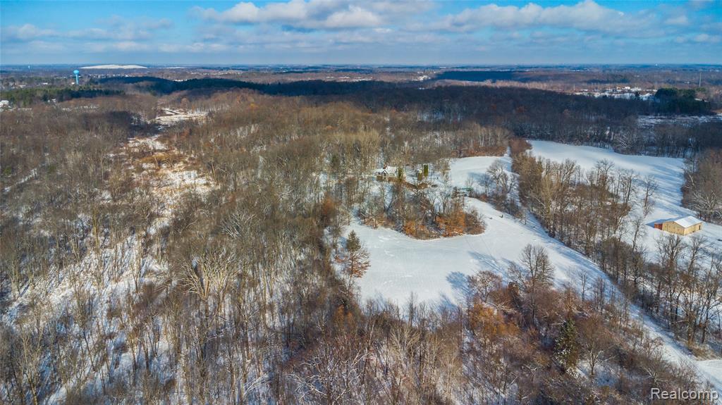 Discover the perfect blend of space, light, and natural beauty in this impressive 5-bedroom, 4-bath home set on almost 24 acres of pure serenity. With room for horses, gardens, outdoor hobbies, and more, this property offers the lifestyle you’ve been dreaming of.  Step inside to be greeted by soaring cathedral ceilings and an inviting open floor plan, anchored by a stunning solarium that floods the home with sunlight through a wall of windows. Relax in front of the wood-burning fireplace on cozy evenings or enjoy peaceful views of nature from every angle. The large kitchen, a chef's delight, is ideal for entertaining and gathering, with a spacious dining room offering beautiful views of the outdoors.  The first-floor laundry adds everyday convenience.  A spacious walkout basement provides endless room for recreation, storage, or future finished living space.  Outside, the possibilities are limitless. Explore acres of woods and wildlife, create a dream garden, or bring your horses and animals—there’s space for it all. With endless potential, this home is blank slate simply awaiting your creative touch to make it truly your own.  Your private retreat, hobby farm, or nature lover’s paradise starts here—don’t miss this rare opportunity!    Welcome Home