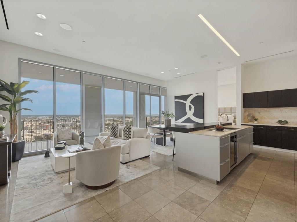 Experience luxury urban living at One Arts Plaza in the heart of the award-winning Dallas Arts District. This contemporary condo is filled with natural light and offers an open-concept floor plan ideal for both everyday living and entertaining. The spacious kitchen features an oversized breakfast bar and flows seamlessly into the living and dining areas. A large covered balcony, accessible from the kitchen, living room, and primary suite, creates exceptional indoor-outdoor living space. The primary retreat includes a spa-inspired bath and generous walk-in closet. A versatile second bedroom features a built-in workspace and Murphy bed, making it ideal for guests or a home office. Enjoy a true lock-and-leave lifestyle within walking distance of the Winspear Opera House, Meyerson Symphony Center, Klyde Warren Park, premier dining, and the best of Downtown Dallas. A rare opportunity to own a sophisticated residence in one of Dallas' most vibrant and walkable neighborhoods.