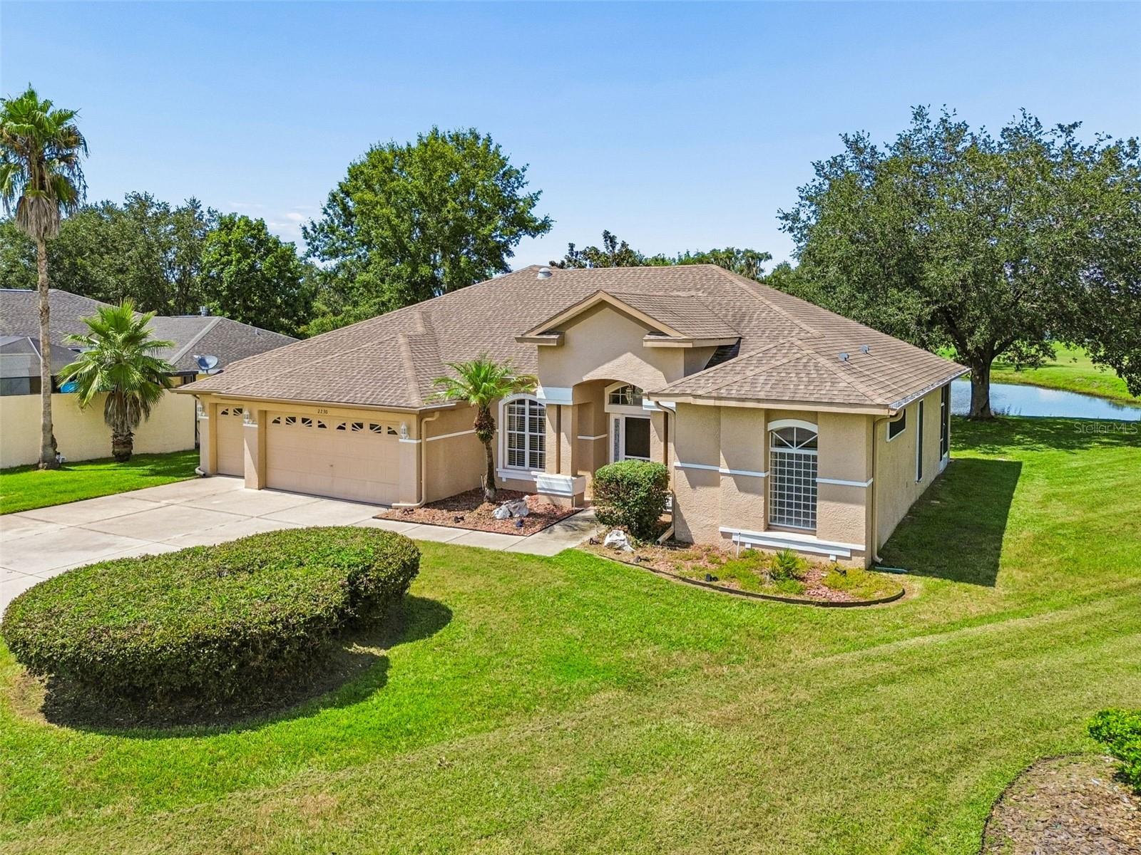 Welcome to 2230 Cross Tee Ct, Brooksville, FL, an inviting home offering 3 bedrooms, 2 bathrooms, 3 car garage and 2,075 square feet of thoughtfully designed living space. The home welcomes you into the large open foyer and formal Dining area. The mater bedroom is Spacious with a sliding door leading to the lanai. The master bathroom contains a massive Walk-in closet and a shower large enough to be fit for royalty.The kitchen is truly regal and opens to the family room. The kitchen features a granite sink, island counter, real wood cabinets and all stainless steel appliances. This home was built around its soaring covered and screened lanai overlooking beautiful serene pond views. There is an outside paved porch that is an open canvas to gardeners or outdoor cooking enthusiasts.  Home contains a water softening system and a Large garage fridge. 2021 A/C. Escape the hustle and bustle of Tampa and enjoy the quiet ambiance of Trails at Rivard.