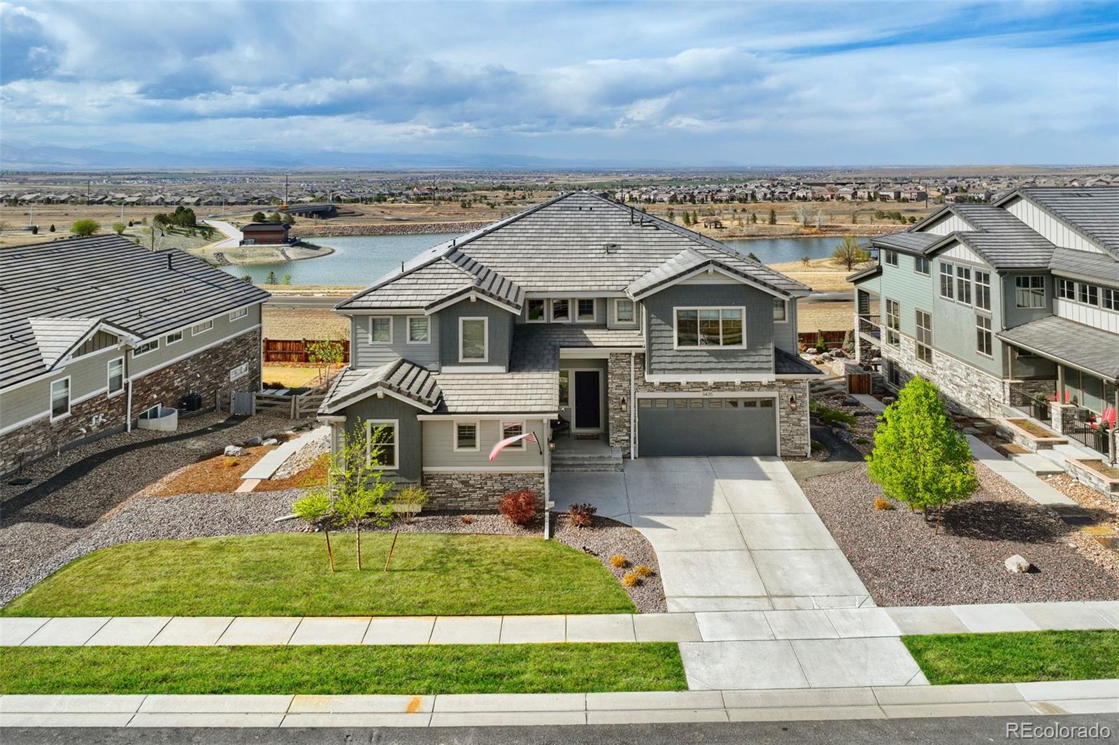 Welcome to Anthem Estates, where elevated living meets unforgettable views. Perched on a hill in one of the area’s most exclusive neighborhoods, this exceptional 6-bedroom, 5.5-bath home offers luxury, comfort, and breathtaking mountain scenery.Built in 2021 with custom finishes and designer touches throughout, this home was crafted with both style and function in mind. The sun-filled main level features stained beams, a natural stone fireplace, updated lighting, and an open-concept layout that flows beautifully into the chef’s kitchen. Designed to impress, the kitchen includes stainless steel appliances, a six-burner range, dual ovens, and a large island perfect for gathering and entertaining. A main-level bedroom or office with a full bath, plus a powder bath and mud room, add flexibility and convenience. Upstairs, the luxurious primary suite is a true retreat, complete with sweeping views, abundant natural light, and private deck access. The spa-like primary bath offers an oversized shower, soaking tub, and dual vanities. Three additional bedrooms include a private en suite and a well-appointed Jack-and-Jill layout, along with an upstairs laundry room for added ease. The finished walk-out basement is built for entertaining, with a full wet bar, theater setup, expansive rec space, and a sixth bedroom for guests or multigenerational living. Outside, the extended deck creates the perfect setting to unwind or entertain, featuring a built-in hot tub, gas fire pit, and plenty of room to enjoy the spectacular surroundings. This home checks every box for luxury living in Anthem Estates.