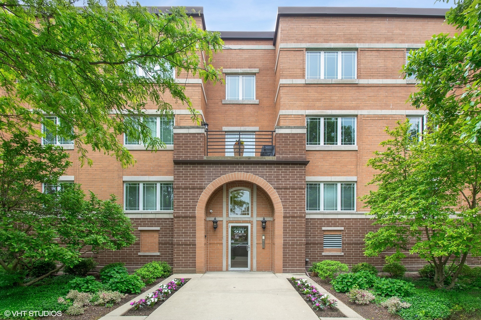 Come experience this impressive condo! Showcasing a top floor location plus a sought-after end, corner positioning with 2 exposures!  A multitude of large, Prairie style windows offer an abundance of natural light and picturesque views. A separate entry foyer sets the stage for generous room dimensions throughout. The open kitchen compliments today's design trends where style meets appeal.  Featuring granite counters and brand-new stainless appliances.  The kitchen also provides abundant cabinets and work area plus additional under cabinet lighting. Delightful breakfast bar overlooks the living/dining area and is perfect for a quick bite or serving guests.  The living room highlights surround sound speakers and versatile options for furniture placement.  Step out to a corner balcony with Prairie style lighting and open views. The primary bedroom is an oasis of comfort with a large walk in closet and ensuite bath, complimented by a soaking tub and walk in shower. A separate fully equipped laundry room with sink offers plenty of storage options.  Updated and upgraded throughout with fresh new paint in a pleasing color palette, new hardwood floors in both bedrooms and tasteful lighting fixtures complete the package. Heated, underground garage with 2 spaces and elevator access make this a lifestyle you won't want to miss.  Enjoy the benefits of living near all that Park Ridge has to offer.