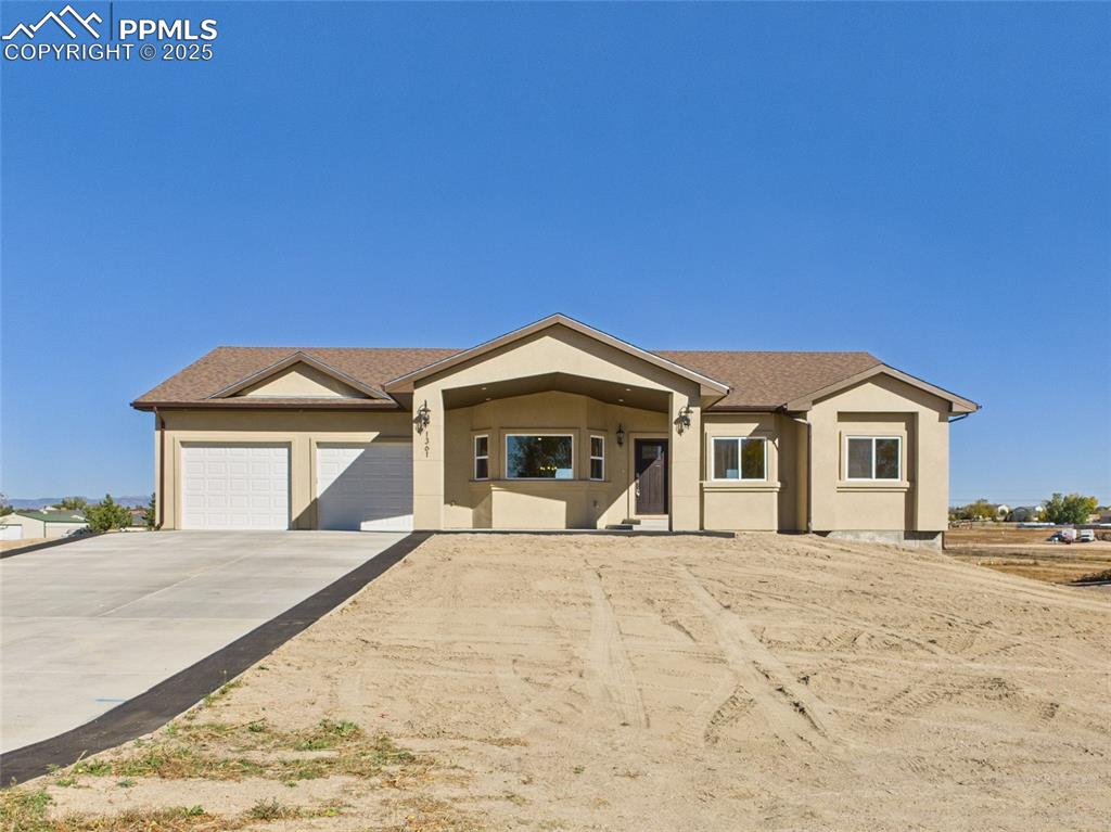 Fantastic new Pueblo West acreage home on a paved road! This thoughtfully designed property offers a unique floor plan with incredible features inside and out. Step into the open-concept main level with soaring vaulted ceilings, perfect for entertaining. The living room boasts an electric fireplace, while the expansive kitchen shines with granite countertops throughout, a large island with a second sink and bar seating, soft-close cabinets, and upgraded light fixtures. The home includes 3 spacious bedrooms and 2 bathrooms. The primary suite is a true retreat with lake views, a massive walk-in closet, and a luxurious ensuite featuring a huge walk-in shower and freestanding soaking tub. The laundry/mud room offers convenient dual entry doors. The lower level provides a blank slate in the unfinished basement—ideal for future customization. Outdoor living is equally impressive with stamped concrete accents, covered patios in both the front and back, and a massive rear deck to relax and soak in the breathtaking mountain views. With room to build a shop in the back, this property combines flexibility, style, and functionality. Schedule a showing today!