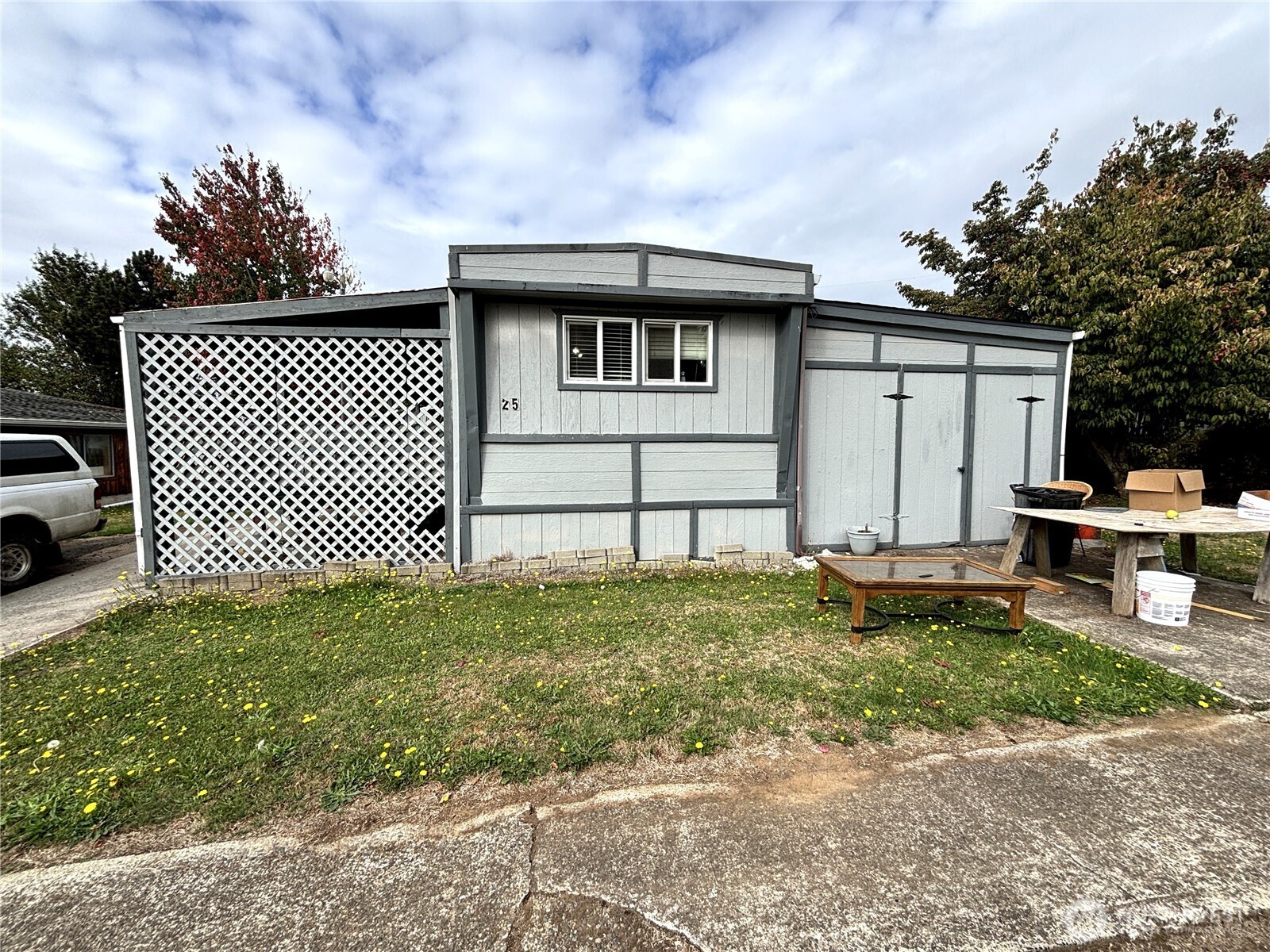Looking for a project? This 1968 single-wide manufactured home is located in Indian Village, a 55+ community, and is ready for someone with the vision and willingness to bring it back to life. The home offers approximately 780 sq ft, plus an additional bedroom space that was started but remains unfinished. A ramp leads to the covered front porch and entrance, while the fenced yard provides usable outdoor space. A separate shed has been set up as the laundry area and includes a NEW washer and dryer, keeping those utilities outside the main living space. This property will require substantial repairs, updates and finishing work throughout and is being sold strictly as-is. Bring your tools, ideas and imagination and see what you can make of this affordable fixer!