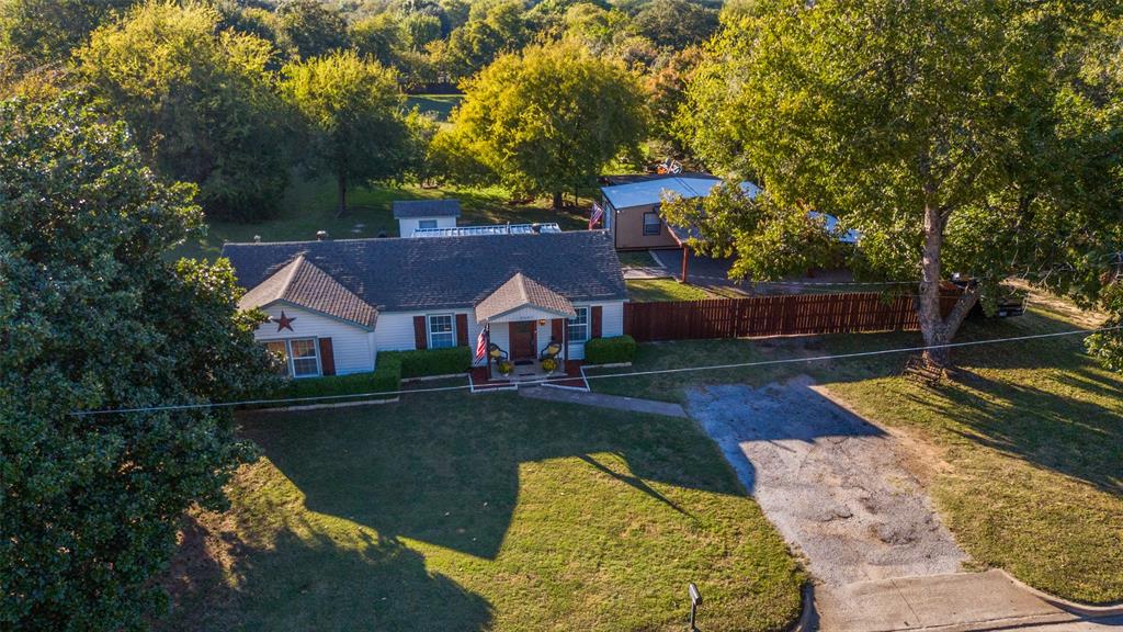 This meticulously maintained residence offers a tranquil county lifestyle in the midst of the metroplex, situated on a spacious 1.272-acre lot. The kitchen was completely renovated in 2019, boasting updated cabinets, granite countertops, LG stainless steel appliances, a gas cooktop, LED under-cabinet lighting, and replaced plumbing featuring PEX lines, drains, and gas lines. Additional updates include new flooring, paint, and a tankless water heater. The bathroom has been refreshed with a tile shower enclosure and a whirlpool tub. A large shop is equipped with a ductless mini-split system, 18,000 BTU Mr. Cool, 100-amp electrical service, and ship-to-shore plugs for an electrical generator. The property is complemented by a metal cedar fence, metal carport, electric gate and UPDATED roof with a Class 4 shingle January of 2026. Seller will consider seller financing.