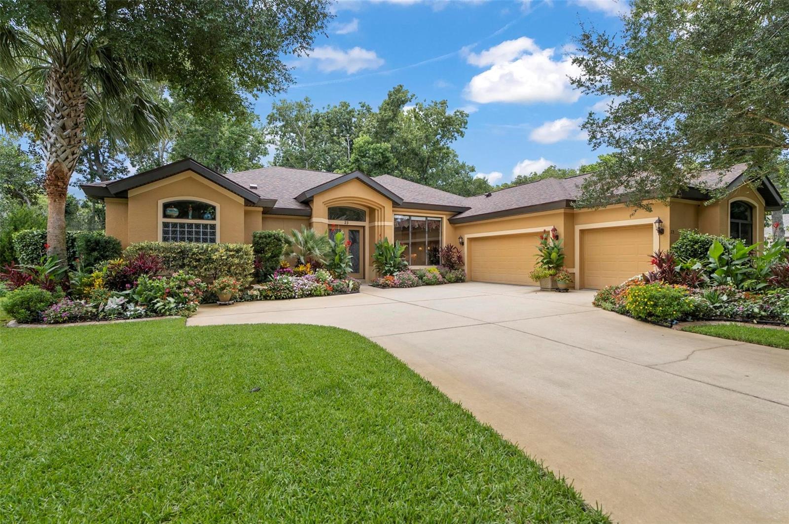 You'll be amazed by the beautifully landscaped front garden, impressed by the thoughtfully designed interior layout and features, and absolutely captivated by the serene backyard lake view! ICI Grand Stratford model in fabulous Creekside Village at Grand Haven offers 4 Bedroom, 3 Bathroom, 3 car garage, and 2633 Sqft living space complete with an oversized L-shaped POOL. This gem showcases 12’ceiling in the main living areas and 10’ in the bedrooms. Recent upgrades include a NEW ROOF and interior A/C unit in 2024.  Meticulously tended, the property features a split floor plan and includes a formal dining room, family room, and breakfast nook for added privacy. The spacious living room features abundant windows and extra-wide sliding glass doors that flood the space with natural light. The primary suite includes a garden tub, oversized walk-in shower, dual vanities, and a large walk-in closet. Both guest bathrooms are equipped with a walk-in tub and shower combination. The elegant kitchen offers sitting area, 42” cabinets, porcelain tile backsplash, and granite countertop. Throughout the home, you’ll find luxury Tiffany-style light fixtures. Enjoy cozy winter evenings by the beautiful gas fireplace. Additionally, the home is equipped with a water softening system, which is beneficial for your health. Generously sized laundry room offers plenty of shelving and a utility sink. The oversized 3-car garage provides ample space not only for vehicles but also for extra storage, a workshop area, or hobby space—perfect for those who need flexibility and functionality. The pool patio overlooks the oversized, lush green backyard and the tranquil lake view. To enjoy the Florida lifestyle to the fullest, take advantage of the exceptional recreational activities this community offers: clubhouse, 2 public pools, 2 restaurants, fitness center, tennis courts, and countless walking trails with street lighting. If you've ever dreamed of living in paradise—this is your place!