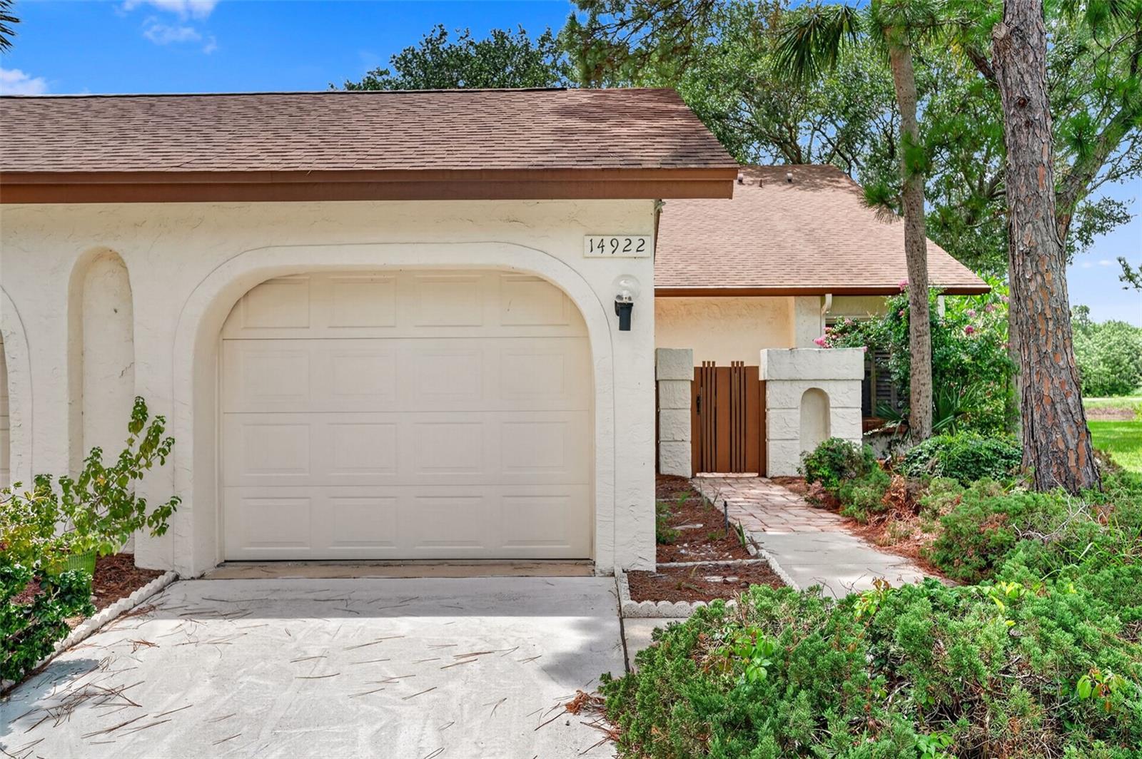 Welcome home to this well maintained 3 bedroom, 2 bathroom end unit in the highly desirable Feather Cove community. Thoughtfully designed for comfortable everyday living, this inviting home features tile flooring throughout the main living areas, luxury vinyl plank flooring in the bedrooms, and a cozy fireplace that creates a warm focal point for the living room.The recently updated kitchen offers a fresh, modern feel with stylish finishes, while the functional floor plan provides a comfortable balance of open living spaces and private retreats. The bathrooms have been well maintained, offering a clean, timeless foundation with the opportunity to add your own personal touches over time.Step outside to your own private courtyard with a beautiful paver patio, an ideal setting for morning coffee, outdoor dining, or entertaining guests. Additional features include a one car garage and a roof replaced in 2017 for added peace of mind.Residents of Feather Cove enjoy a beautifully maintained community pool and an exceptional location just moments from the Feather Sound Country Club, major roadways, shopping, dining, Tampa International Airport, and all that Clearwater and St. Petersburg have to offer.