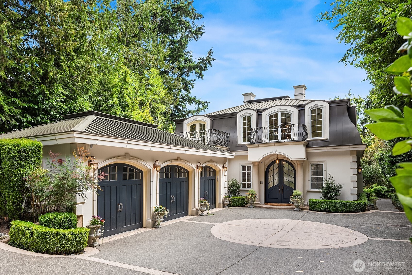 A distinctive gated estate in one of the nation’s most coveted neighborhoods. This Mediterranean-style residence features cathedral ceilings, Italian columns, and French doors opening to serene patios and a 200-ft dock with year-round moorage. Gorgeous wrought iron railings, crystal chandeliers, and a whole-house sound system add to the refined ambiance. Each bedroom is an ensuite. Downstairs offers relaxation with a wine cellar, spa, cold bar and terraces. Chef’s kitchen is outfitted with brand-name appliances. Curved design flows through the lush, landscaped grounds of this Lake Washington shore house. Mature trees, vibrant blooms, and curated shrubs welcome visits from blue herons and bald eagles. Fountain, BBQ island, firepit, dog run.