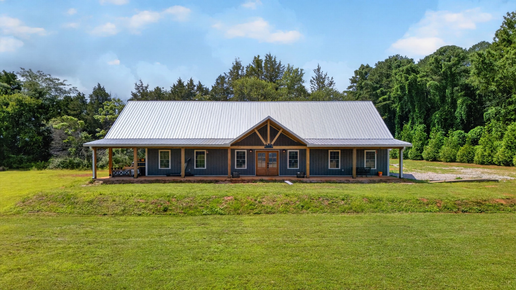 Privacy meets convenience in this beautiful Belvidere home tucked away on a quiet dead-end road—yet less than 20 minutes to town. Offering approximately 3,000 sq ft, this home features 9’ ceilings throughout, with a stunning vaulted living room and kitchen accented by tongue-and-groove ceilings. The spacious kitchen boasts a massive 12’ island—perfect for entertaining—while a large bonus room adds flexibility for any need. Unwind in the evenings on the beamed porches complete with a swinging bed. Additional highlights include a storm shelter, conditioned storage room, office/flex room and dual fuel HVAC system. Truly a home that checks all the boxes!