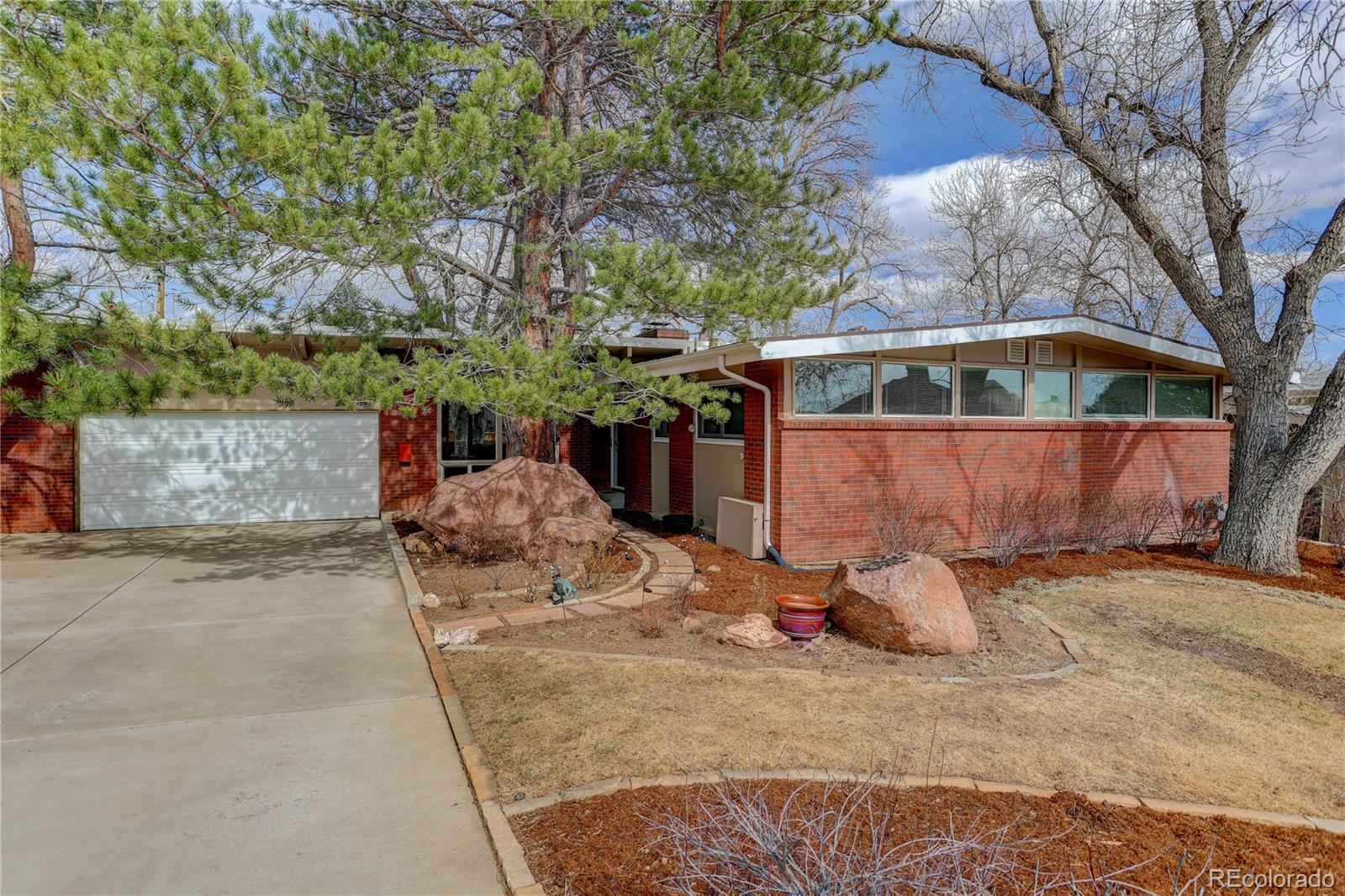 A serene SoBo retreat. Originally built in 1963 as an Eichler-inspired California Modern, this Highland Park ranch has been reimagined into a warm, light-filled 4BD/3BA home that fits how people live in south Boulder today. Step inside to a gracious entry and an expansive, sun-drenched living room where a wall of glass faces South and pulls in southern sunlight light all day, creating an inviting setting for both quiet mornings and easy entertaining. Warm updates, oak hardwood, and clean lines honor the mid century bones while dialing the vibe into now, with flexible spaces for kids, guests, or a true work from home setup.The heart of the home flows easily from living to dining to an open kitchen and great room-style space that connects to the outdoors. Sliding doors open to a private, thoughtfully landscaped yard large enough for gardens, play, and summer dinners, yet still manageable for busy people who would rather be on the trails than behind a mower. Three bedrooms and two updated baths on the main level allow for one-level living with options for guest space, nursery, or office.Downstairs, a separate entrance leads to a versatile lower-level suite with its own living area, second fireplace, bedroom, and full bath; ideal as a mother in law or guest suite, multigenerational living, an Au Pair, or a private office/studio. Practical upgrades, including a 2025 furnace, 2026 roof certification, and a one-year home warranty to the buyer at closing, add peace of mind.Outside your door, one of Highland Park’s most loved streets puts the Flatirons in your daily sightline instead of just a weekend hike. Enjoy the Mesa / Bear Creek / Fairview school trifecta, quick access to open space and trails, and an easy hop to Table Mesa shops, cafés, and US-36 to Denver or the airport.