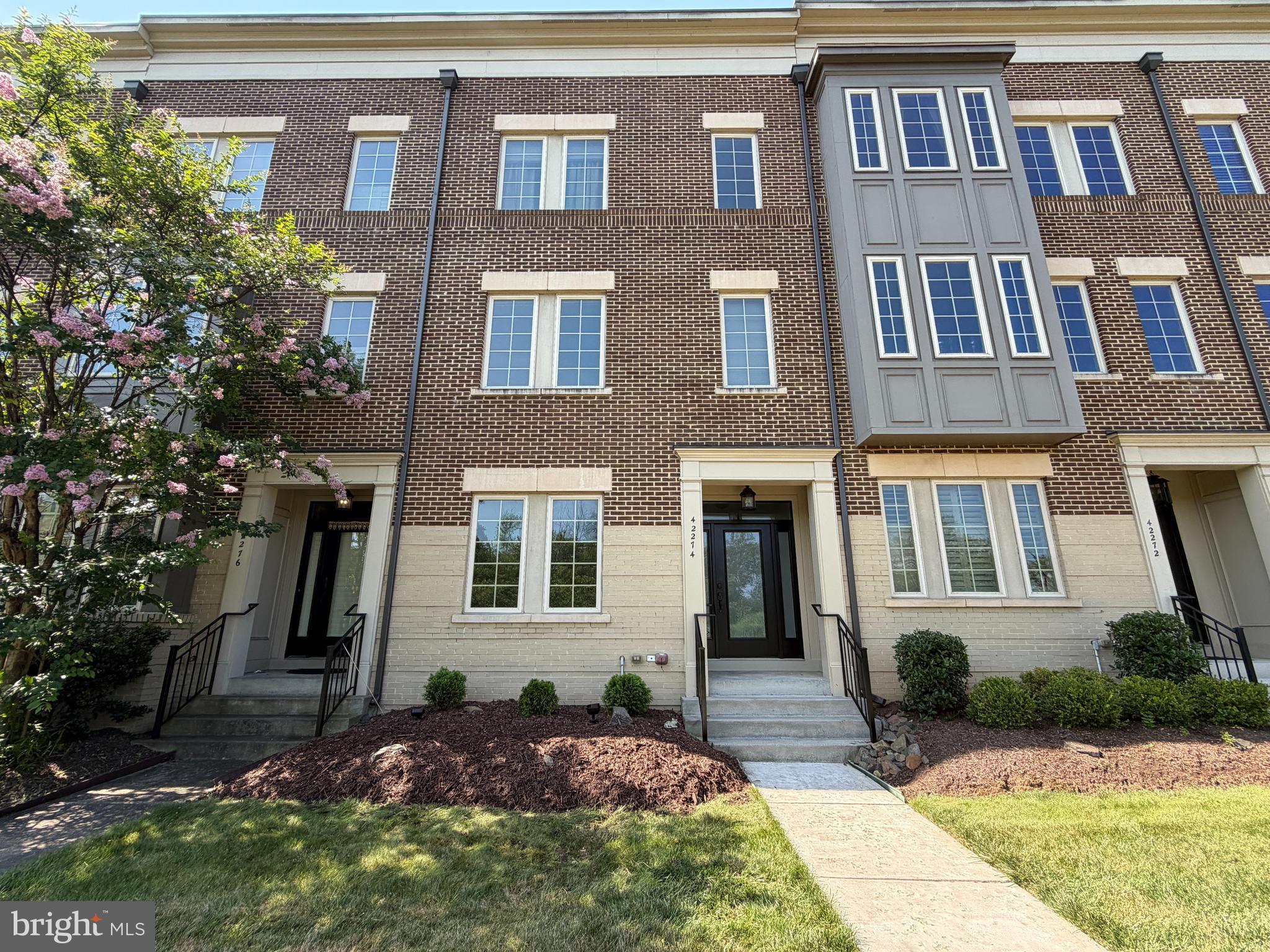 Welcome to this beautifully refreshed Miller & Smith Brownstone, offering approximately 2,512 square feet of thoughtfully designed living space across three finished levels. This move-in-ready home features four bedrooms, three full baths, and one half bath, combining timeless style, everyday comfort, and the ease of low-maintenance living.Freshly painted from top to bottom, the home has been thoughtfully refreshed with newly refinished hardwood floors, brand-new carpeting, and abundant natural light throughout. The entry level offers a spacious recreation room, a full bath, and a fourth bedroom, guest suite, or home office.The open-concept main level is designed for both comfortable everyday living and effortless entertaining. The kitchen features stainless steel appliances, granite countertops, a large center island, stylish pendant lighting, and ample cabinet space, flowing seamlessly into the dining area and inviting family room. A striking floor-to-ceiling stone gas fireplace serves as a warm and inviting focal point, creating the perfect gathering space for family and friends.Step outside onto the private balcony overlooking mature trees, where a retractable awning provides welcome shade on sunny afternoons, making it the perfect place to enjoy your morning coffee or unwind at the end of the day.Upstairs, the spacious primary suite offers a relaxing retreat with an en-suite bath, and two walk in closets.  Two additional bedrooms, a third full bath, and a conveniently located laundry room complete the upper level.Additional highlights include a low-maintenance exterior and access to Brambleton's outstanding HOA amenities, including Verizon Fios high-speed internet and cable TV, lawn maintenance, trash and recycling service, five outdoor pools, miles of scenic walking and biking trails, numerous parks and playgrounds, pickleball and tennis courts, and an active calendar of community events.Perfectly positioned directly across from Brambleton Golf Course, this home also enjoys one of the community's most desirable locations. Just a short stroll away, Brambleton Town Center offers an outstanding selection of restaurants, shopping, entertainment, fitness, a public library, movie theater, seasonal events, and everyday conveniences—making it easy to enjoy everything this vibrant community has to offer right outside your door.