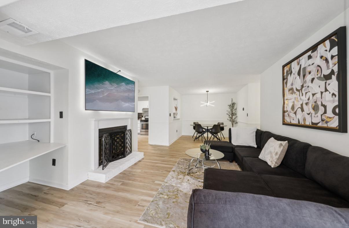 Welcome to turnkey perfection in the heart of Reston, where style, comfort, and unbeatable convenience come together. This beautifully reimagined garden-style condo offers the ultimate in low-maintenance living and has been fully renovated from top to bottom, making it completely move-in ready with nothing left to do. From the moment you step into the welcoming foyer, you’ll notice the attention to detail and quality upgrades throughout.Upstairs, the home opens into a light-filled, open-concept living space designed for both everyday living and entertaining. The stunning bright kitchen features sleek quartz countertops, stainless steel appliances, refinished cabinetry with updated hardware, and a stylish tile backsplash, all complemented by brand-new lighting. Throughout the home you’ll find gorgeous luxury vinyl plank flooring, fresh designer paint, updated light fixtures with dimmers, and modern finishes that create a cohesive and elevated feel.  The spacious living room with a cozy fireplace flows seamlessly into the dining area and a versatile sunroom that works perfectly as a home office, reading nook, or flex space, and leads directly to a private balcony. A mounted living room TV conveys with the property, and the home has been barely lived in, offering a like-new feel. The cozy primary suite  features a large walk-in closet. The bathroom has been tastefully updated with a double sink vanity offering excellent storage, along with a conveniently located in-unit washer and dryer.Located in one of Northern Virginia’s most desirable communities, this home offers exceptional access to everything Reston has to offer. Enjoy being just minutes from Reston Town Center with its vibrant mix of shopping, dining, and entertainment, along with nearby parks, trails, and everyday conveniences. Commuters will appreciate the easy access to the Dulles Toll Road and Fairfax County Parkway, as well as close proximity to Silver Line Metro stations for a seamless trip into Washington, DC. Washington Dulles International Airport is just a short drive away, and Reston Hospital Center is nearby, adding to the everyday convenience of this prime location.  This pet-friendly, garden-style condo combines modern upgrades, a barely lived-in feel, and an unbeatable Reston location, offering a rare opportunity for a truly turnkey home where everything has already been done for you.  This won't last!