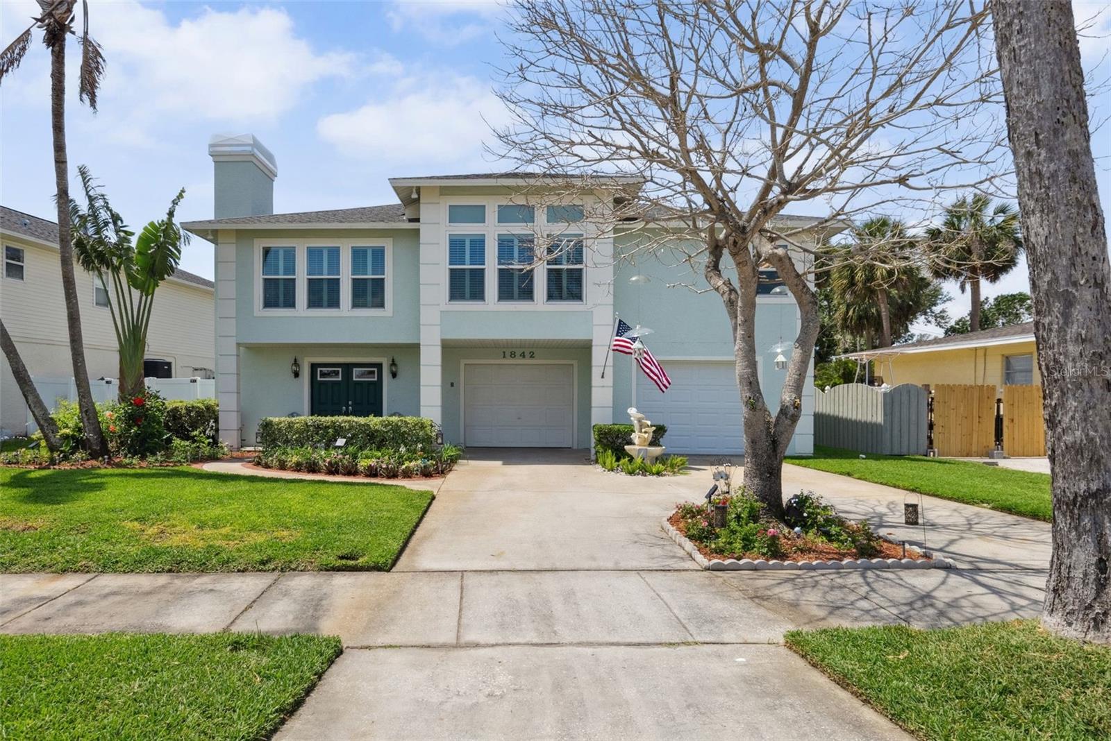 Welcome to 1842 Bayou Grande Blvd NE – where elevated living meets exceptional functionality. This impressive residence offers over 2,500 sq ft of living space, 3 spacious bedrooms, 2.5 baths, and a garage setup that’s truly a rare find.

The oversized 5+ car garage is a dream for car collectors, boaters, DIY enthusiasts, or anyone in need of serious storage. With multiple parking bays, built-in tool organization, generous cabinetry, and direct access to the backyard and pool area, this space easily doubles as a workshop, man cave, or flexible recreational zone. Whether you’re tackling projects or hosting poolside gatherings, the garage is as versatile as it is expansive.

All main living areas are elevated, with access via a wide staircase and a convenient chair lift. Upstairs, you'll find a light-filled layout with an open living and dining area that connects to a large upper deck—perfect for enjoying morning coffee or evening breezes. The living room features a cozy wood-burning fireplace, perfect for cool evenings or adding charm to your entertaining space. The unique, octagon-style kitchen offers great prep space, a walk-in pantry, and bar seating, overlooking the living area for easy entertaining.

The primary bedroom features high ceilings, two closets, and an ensuite bath with double vanities, a soaking tub, and a walk-in shower. Two additional bedrooms and a full bathroom are located down the hallway, along with a dedicated laundry room.

The home also includes hurricane-rated windows on the front elevation for added peace of mind.

Step outside to your private backyard oasis—complete with a pool, tropical landscaping, and plenty of space for relaxing or entertaining under the sun.

Located just minutes from parks, local waterfront spots, downtown St. Pete, and easy access to I-275 and the airport, this home combines comfort, convenience, and incredible storage potential.