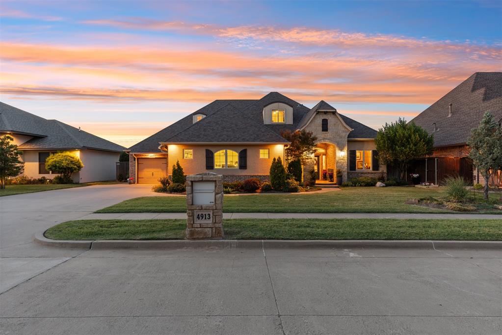 Impeccable condition, true custom craftsmanship and an exceptionally versatile floor plan distinguish this 3,608-square-foot home in Arbor Lake. Meticulously maintained by only two owners, it presents in genuine show-home condition with 3 bedrooms, 3 and a half bathrooms, a dedicated study and 3 separate living areas, including a private theater room. The brick-and-stone exterior and deep covered entry introduce an interior filled with rich custom woodwork, hand scraped wood flooring, generous room sizes and remarkable storage.The open kitchen anchors the main living areas with a large center island, prep sink, gas cooktop, double ovens, serving bar and walk-in pantry. All 3 bedrooms are conveniently located on the main level, including a spacious primary suite with patio access, a beautifully updated bathroom with heated flooring and an oversized custom closet. The study’s built-in cabinetry creates an ideal home workspace.Upstairs offers a private retreat with a large bonus or game room, wet bar and separate theater room. Outside, an expansive covered patio and outdoor kitchen overlook the beautifully landscaped backyard and broad western horizon, with a clear northern view extending to the Devon Tower in downtown Oklahoma City.Additional features include a 3-car garage, utility room with sink, central vacuum, sprinkler system and abundant built-in storage throughout. Exceptionally cared for and thoughtfully designed, this is a home whose quality is best appreciated in person.