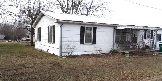 200 x 90 Lot with multiple entrances to this corner lot. Park in front or go to the side to enter the 2 car garage or enter from another street. If your interest is working in your garage then this is perfect for you as it has a gas furnace, concrete floor, overhead and walk-through door. 4 BR, 1 BA house. (Base)wood flooring has been replaced, several rooms sheet rock has been replaced, load bearing beam the length of the house and floor joists also replaced where needed. New carpet. Metal roof in 2022, also water heater. Attached house garage was converted into Primary BR/Office. Fireplace in LR is electric. Large yard is perfect for kids dirt bike track, places to park the fishing boat, trailer or RV. Spacious heated garage is a dream place to work. Covered wood deck off the kitchen is large enough to have a table and a grill. Property comes with a dog pen. Owner got creative with plywood and torch for the kitchen floor.