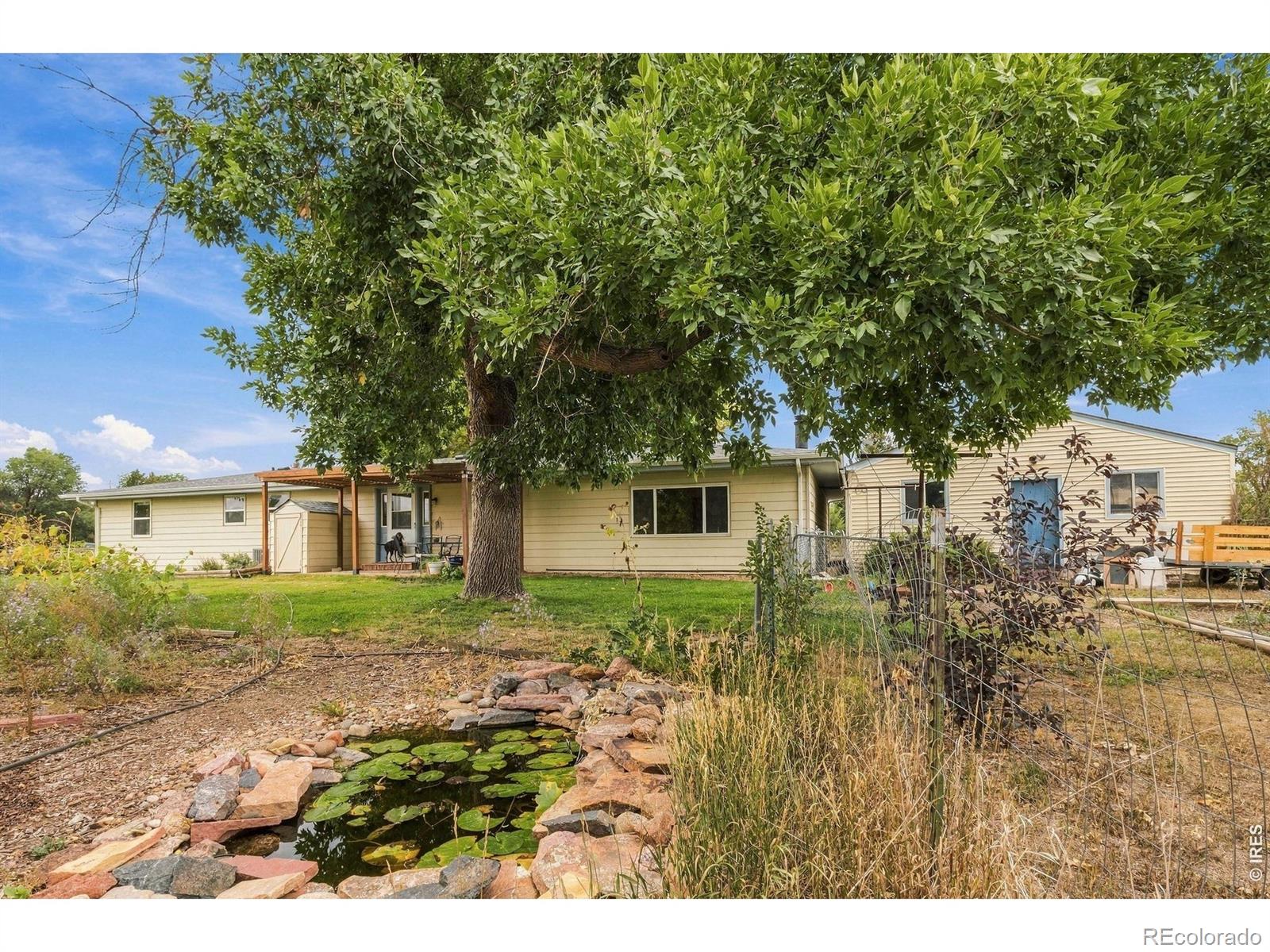 Rare find! This sprawling one-level ranch sits on 2.13 acres with no HOA, ideally located between Longmont and Berthoud with quick access to Hwy 287.Step inside and fall in love with the bright, welcoming interior. Fresh, gleaming updates make the kitchen the heart of the home, a space you'll love cooking, gathering, and entertaining in. The easy single-level layout offers 3 bedrooms, 2 baths, and 3 separate living areas, giving you flexible space for family, guests, or a home office. Peace of mind comes built in with a new roof and gutters (2024), a new water heater (2025), and HVAC (2019). Solar panels help offset energy costs, and a fast, smart, universal EV charger (2025) is already installed.Outdoor living at its best! Garden, let the pets run, and watch the wildlife at your own pond, all in your backyard. Established gardens and numerous mature shade trees surround the home. The property is fully equipped for animals, with a loafing shed for horses, a pen for goats, a chicken coop, a shed, and fencing for horses, alpacas, and other livestock. A 750 SF workshop and a 550 SF garage give you space for projects and hobbies, while the exterior 30-amp RV hookup is ready for your next adventure.Enjoy the lower property taxes of Larimer County, plus the confidence of a recent Larimer County septic inspection.Residents have shared water rights from Horseshoe Park Water Company.