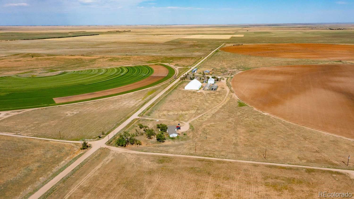 The Rush Irrigated Farm is a productive and multi-dimensional agricultural property positioned in the heart of eastern Colorado farm and cattle country. The property is designed to accommodate a wide variety of agricultural and livestock operations. From row-crop production to forage programs, cattle development, greenhouse use, or diversified agribusiness, the farm offers the scale and flexibility to support long-term success. Of the 800 deeded acres, 355 acres are irrigatable and are currently serviced by three center-pivot sprinkler systems. The remaining acreage consists of native grass pasture and dryland fields. Two pivots had been planted in sorghum-sudan in the past, while a corn crop had recently been harvested from the third, demonstrating the property’s rotational versatility and forage production capability. Irrigation water is supplied by three irrigation wells, each tied directly to a pivot. A fourth well exists on the property and may be re-drilled and returned to service, allowing future capacity or redundancy. The farm supports a wide range of agricultural operations, including: • Row-crop production • Alfalfa and small grains • Sorghum-sudan and forage crops • Cow-calf or yearling grazing • Horse and livestock programs • Hemp or specialty agriculture • Greenhouse and controlled-environment production