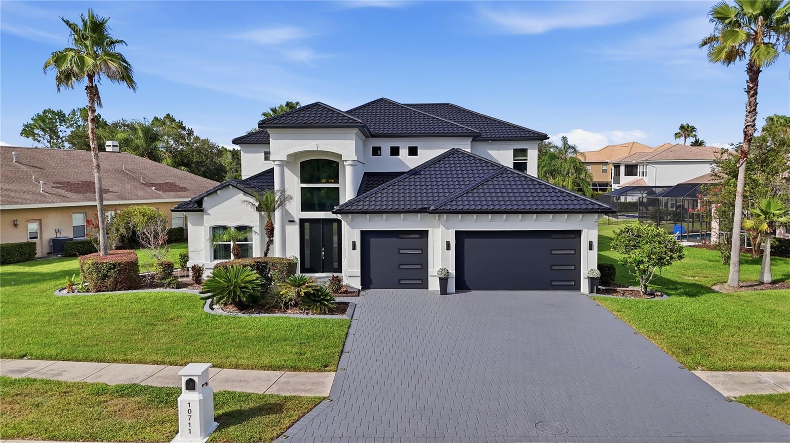Experience extraordinary lakefront living in one of Tampa's most prestigious gated communities. Perfectly positioned on one of the most desirable homesites in Cory Lake Isles, this exceptional waterfront estate captures sweeping panoramic views across the community's 165-acre ski lake with a picturesque backdrop of mature trees, creating one of the most breathtaking settings in the neighborhood. This truly turnkey residence is ready to be enjoyed from day one. Lovingly maintained and extensively upgraded, this stunning home offers 3,786 square feet of thoughtfully designed living space with 4 bedrooms, 3.5 bathrooms, a private office, an expansive bonus room, and a 3-car garage, all situated on a premium .39-acre homesite. A grand two-story foyer welcomes you into soaring ceilings, expansive living spaces, and spectacular lake views. Imported Tarsus Almond porcelain tile from Turkey flows throughout the main living areas, while rich hardwood flooring extends throughout the rest of the home. Nearly every room showcases breathtaking water views. The spectacular chef's kitchen has been beautifully remodeled with custom cabinetry, dual oversized islands, a dedicated wet bar and coffee station, premium granite countertops with a full-height matching granite backsplash, top-of-the-line KitchenAid appliances, a gas cooktop, built-in wall oven, microwave, and abundant storage. The dramatic two-story family room is anchored by a floor-to-ceiling stone fireplace with a sleek linear electric fireplace, while oversized windows flood the home with natural light and frame the incredible waterfront setting. The spacious first-floor primary suite offers direct access to the lanai and pool, tranquil lake views, dual walk-in closets, and a luxurious spa-inspired bath finished with imported Turkish marble. Upstairs you'll find three generously sized bedrooms, including a private en-suite ideal for guests or multigenerational living, an expansive bonus room with a custom wood accent wall, and an oversized balcony where two bedrooms enjoy spectacular lake views. Outdoor living is equally impressive with a heated saltwater pool featuring a sun shelf with bubblers and umbrella sleeve, elegant imported Turkish marble decking, an expansive covered lanai, and a private dock, creating the ultimate setting for entertaining or enjoying the waterfront lifestyle. Whether it's boating, waterskiing, wakeboarding, paddleboarding, kayaking, or bass fishing, this 165-acre ski lake offers endless recreation right from your backyard. Recent improvements include a brand-new metal roof, hurricane-impact double-pane windows, impact-rated garage doors and front door, new fascia, gutters, fresh exterior paint, beautifully remodeled kitchen and baths, and a newer pool heater. Behind the 24-hour guard-gated entrance, Cory Lake Isles offers a private beach club, lagoon-style pool with waterslide, fitness center, tennis courts, basketball courts, sand volleyball, roller hockey rink, soccer field, playgrounds, parks, community boat ramp, and year-round social events. Timeless craftsmanship, exceptional upgrades, panoramic lake views, and an unparalleled waterfront lifestyle combine to create one of Cory Lake Isles' finest luxury offerings.