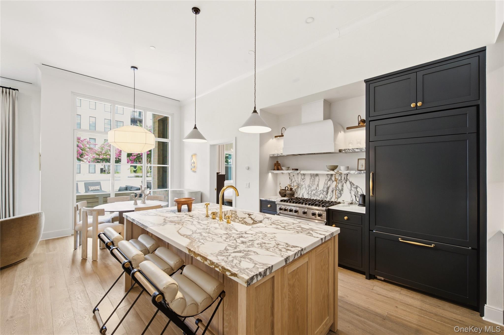 Experience elevated waterfront living at 1007 The Beacon at Garvies Point. This exquisite, fully renovated 2-bedroom, 2-bathroom residence seamlessly blends modern elegance with unparalleled indoor-outdoor living. Defined by soaring 12-foot ceilings and refined finishes, the home is a testament to meticulous craftsmanship. The chef-inspired kitchen is a culinary masterpiece, featuring custom cabinetry, premium Italian Arabescato Corchia marble countertops, and professional-grade Viking appliances. Every detail has been curated, including custom solid white oak shelving in the living room and a bespoke built-in desk and library in the guest bedroom. For ultimate convenience and comfort, the home includes all-solid brass hardware, custom closet systems, and remote-controlled blackout privacy shades throughout. The home’s true crown jewel is its expansive 1,366-square-foot private terrace—a magnificent entertainer’s sanctuary. This outdoor oasis is fully equipped with a kitchen, jacuzzi, gas fire pit, dining space for twelve, a surround-sound system, and all-weather television, all furnished with pieces from Restoration Hardware. It even includes an invisible Fido fence installed beneath the stone tiles. Nestled within a serene 56-acre waterfront community adjacent to a nature preserve, this home offers a tranquil escape just an hour from Manhattan. Residents enjoy exclusive access to resort-style amenities, including a 24-hour concierge, pool, fitness center, and screening room. Offered fully furnished, including all artwork and light fixtures, this residence is truly turnkey.