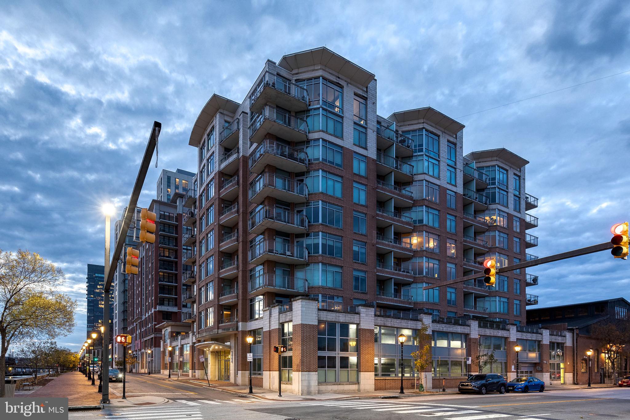 Desired Harbor East location.  Meticulously maintained (1853 sq. ft. of living space), turnkey,  2 level, 2 bedroom, 2.5 baths, east facing light filled unit with walls of windows in living room,  dining room and primary suite.  Gourmet kitchen features granite counters, breakfast bar,  double sink, weave tiled back splash, garbage disposal, wall oven/microwave and gas range.  Main level office (exclusive of this unit).  Engineered hardwood flooring throughout and radiant heated floors on main level.   Large patio off dining room, (grills allowed), views of historic Fells Point.  Upper level includes 2 Bedroom Suites with En Suite Bathrooms. Primary bedroom faces east,  walk out to a large balcony and relax, unwind and enjoy the views.  Spa like primary bathroom features corner jetted jacuzzi tub, double sink with granite counter, travertine tile floor and walk in shower. Laundry room is easily accessed by both bedrooms.  2nd bedroom includes balcony access,  lots of natural light from east facing windows, walk in closet providing room for storage.  Upgrades include: HVAC/gas heat system (2 years),  custom blinds, neutral color paint throughout.  Secure assigned garage parking with secure storage area.  Need parking for guests?  There is a list available to owners of units that  have parking spots available if needed.  A fine feature of this building is the on site security staff and concierge service.  Enjoy the maintenance free lifestyle this amazing property has to offer.  Walk or bike ride to restaurants, shopping and entertainment.  Make an offer today!!!