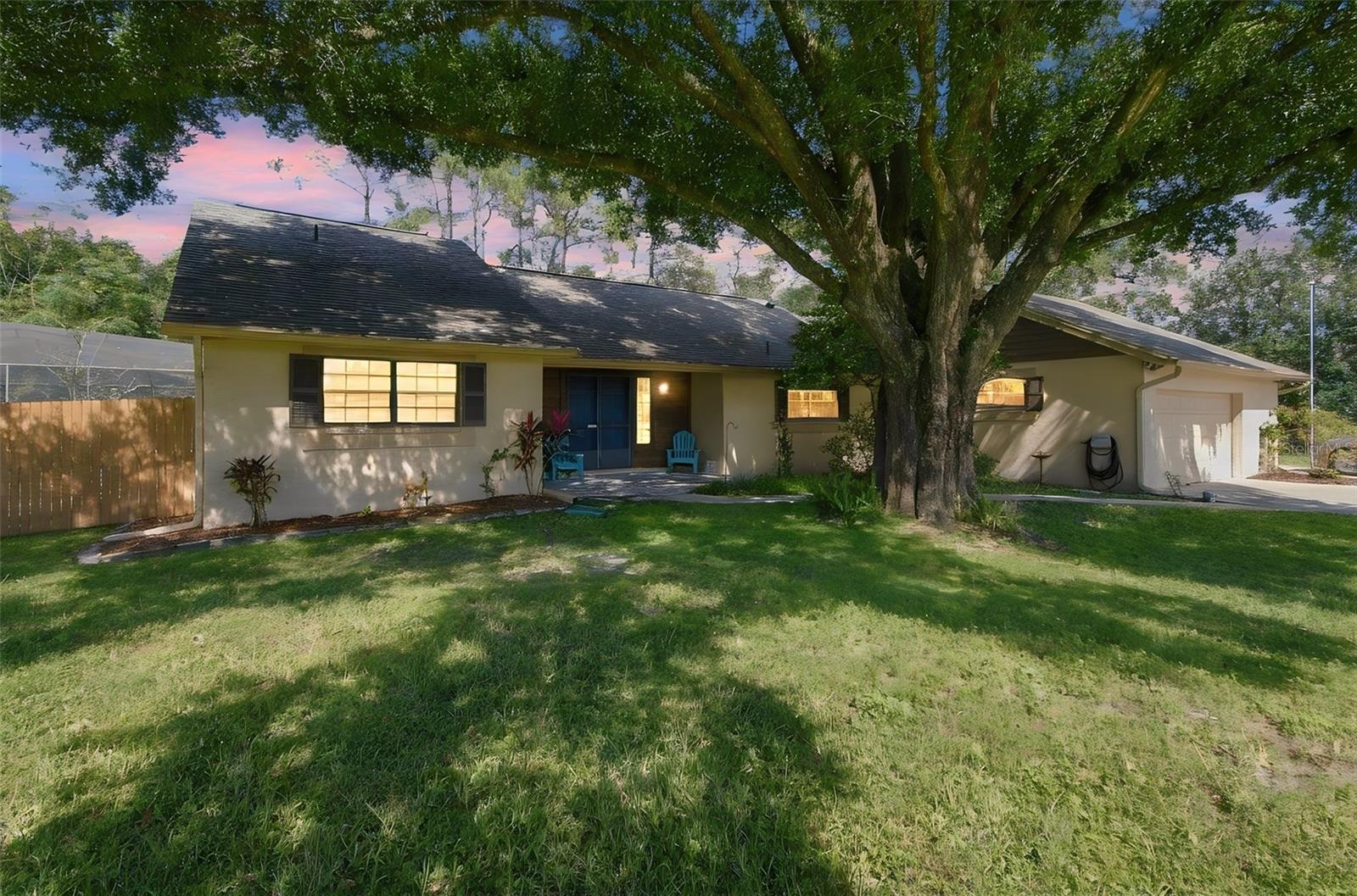 ALWAYS WANTED A POOL? NEVER HAVE ENOUGH GARAGE SPACE FOR ALL OF YOUR TOYS? THS HOUSE HAS IT ALL!!Double doors lead to a tiled foyer overlooking a spacious great room with a stone fireplace, vaulted ceilings, vinyl wood flooring and glass sliding doors to an 18x28 screened lanai with heated pool and spa.  Enjoy the eat-in kitchen with large island bar and generous cabinets with drawers and pull-out shelving plus a water filtration system.  The dining room is conveniently located off the kitchen. A split bedroom plan offers a primary suite 14x17 and the other 2 bedrooms are 12x13.  The roof was installed in 2024, the hot water heater in 2023, the air conditioer is 6 years old and the exterior was painted in 2024.  For the person with lots of toys, you will be OVER THE MOON when you see the 4  CAR GARAGE (1080 SQ.FT.)  with built-in storage, a powered lift to an insulated attic with flooring and shelving.  The garage has 2 overhead doors, one in the front and one on the side, an air filter and a mini split a/c.  If that's not enough, there is a 12x20 storage building (2 year od roof) and 50/30 and 20 amp RV service for your RV.  The property is .46 of an acre with a cypress wood privacy fence and backs up to a designated horse riding trail.  Lake Padgett Estates offers residents access thru designated parks to 3 ski lakes and 1 smaller fishing lake, horse stables on an as-available basis and tennis courts.  The access park is located across the street from this property.  Land O'Lakes Library and Sports Complex are just approx. 2 miles and are within biking distance,  Golf carts are a popular sight.  Come and enjoy this laid back lifestyle like in days gone by.