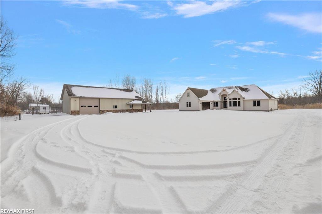 Discover the stunning country retreat you've been dreaming of, complete with numerous upgrades and timeless charm. Tucked deep into the woods on nearly 7.5 acres, this expansive 3,094-square-foot ranch offers an inviting open layout and serene privacy. The impressive 60 x 40 pole barn is a true mechanic's paradise, featuring 220V power, two 14 x 12 doors, a full cement floor, and a converted porch extended with stone. The home is connected to natural gas  (NO propane), and the previous geothermal system remains available if desired. Inside, the remodeled kitchen opens seamlessly into the family room, showcasing panoramic bow windows that frame peaceful views of the wooded trails behind the home. The exceptional primary suite includes a jetted soaking tub, a separate walk-in shower, and an oversized closet. The fourth bedroom is currently used as an office, offering great flexibility for your needs. Need more space? The 24 x 12 finished bonus room above the garage provides fantastic additional square footage-perfect for a fifth bedroom, theater room, craft room, or whatever suits your lifestyle. The basement is enormous, boasting high ceilings and endless potential for future finishing or storage