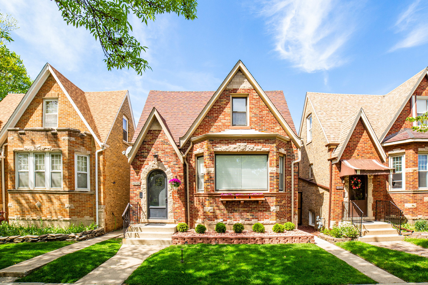 Charming English Tudor in Portage Park featuring 5 bedrooms, 3 full baths, and a fully finished basement in-law suite with its own deluxe kitchen and laundry. The main level includes refinished hardwood floors, a remodeled kitchen with quartz counters and custom cabinetry, updated lighting, and fresh paint. Additional highlights include new carpeting upstairs, walk-in closets, and a dedicated den. Major upgrades like Space Pac central air, spray foam insulation, and a new sump pump offer peace of mind. A rolling rear gate, heated garage, and beverage station round out this turnkey home ideal for extended living or rental income.    In-law suite includes full kitchen, laundry, and private entrance. New HVAC (Space Pac) 2023, sump pump 2024, insulation upgrades, and LED lighting throughout. Full kitchen remodel 2024. Two dens/offices, two laundry rooms, custom shelving, heated garage with AC. Rolling rear gate with man gate.