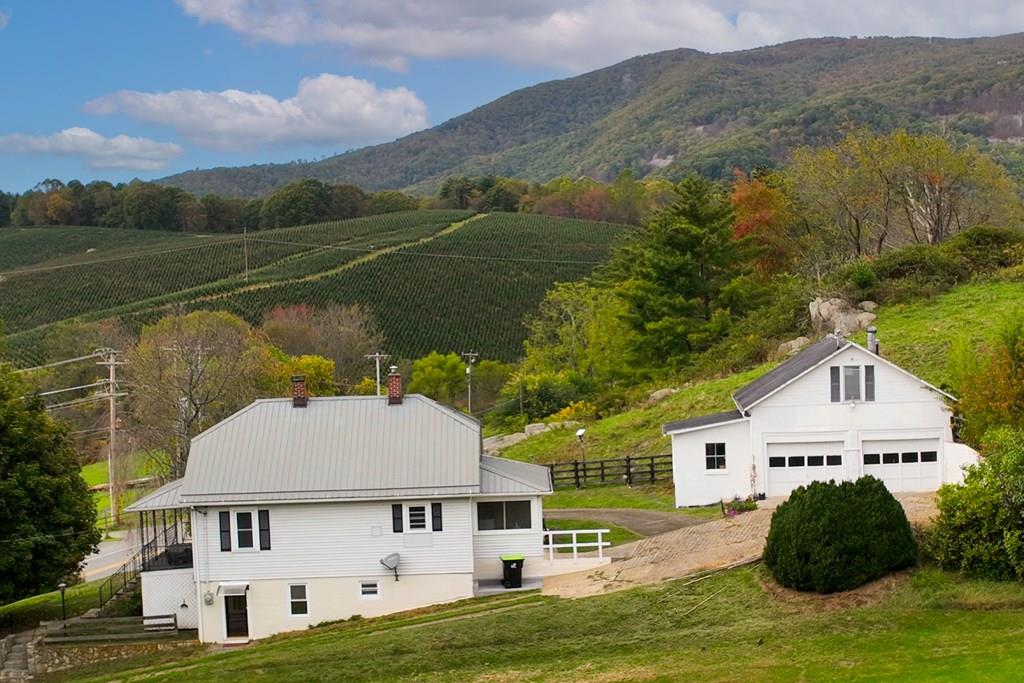 Move-in-ready, full renovated 4/2 home with Studio Apartment, detached 2 car garage, Workshop, Office, Barn,Shed and Scenic Blue Ridge Setting.  This versatile property in the heart of Independence offers a rare blend of modern upgrades and timeless character suggesting endless potential.  From the top to bottom, the main house has been thoughtfully remodeled with respect for its original vintage charm.  Fresh interior and exterior paint, stain, upgraded fixtures, fans, appliances, solid wood cabinetry, vanities, countertops, and flooring; throughout create a turn-key ready space that still feels as an inviting farmhouse should.  The plumbing and electrical have also been updated to accommodate modern appliances. Insulation in attic and in-ground stormwater drainage systems were newly installed to offer peace of mind for years to come.  Both chimneys, the metal roof, gutter, the wood stove, and the oil heating system have been professionally serviced. The heating oil tank is full and ready for winter months.  Downstairs, the separate-entry studio apartment has been completely gutted and rebuilt with moisture resistant, quality materials.  This tastefully decorated, bright space is ideal as a private in-law suite, guest quarters, rental income unit, Airbnb, or creative space. It's a perfect retreat with the flexibility to generate revenue or support multigenerational living.  As a plus, it has its own driveway.  Out back, a detached office and workshop space invites further transformation-whether into a home business hub, art studio, storage loft, or even a fully separate two-story residence.  The 0.55-acre lot is well-suited for self-sustaining gardens, play areas for children, and/or pets.  The existing barn and shed await your personal touch to house animals or hobby farming.