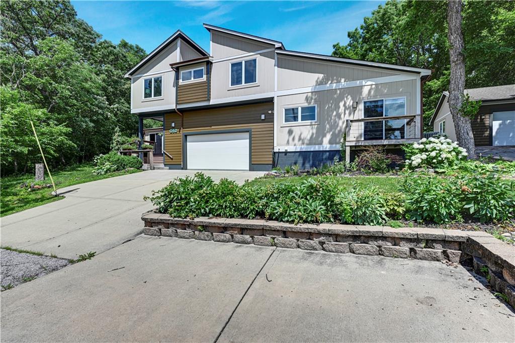 Some homes are houses. Others are a gateway to the lake lifestyle. Welcome to 52 G Street in Shawnee Cove, offering more than 3,750 square feet of living space designed for comfort, connection, and making memories at the lake. This spacious home features 5 bedrooms and 4.5 bathrooms, providing plenty of room for family, friends, and weekend guests who never seem to want to leave.Inside, you'll find generous living areas filled with natural light, updated finishes and a layout that works beautifully for both everyday living and entertaining. Whether it's hosting a summer dinner after a day on the water or enjoying a quiet morning with coffee before the lake comes alive, the home offers the space and comfort that make lake living easy.  Step outside and the lifestyle continues. The property includes a shared double well dock with access to one of the boating wells along with jet ski lifts, making it simple to get out on the water whenever the mood strikes. Direct access to the dock via a convenient pathway—perfect for a gentle stroll or a quick, easy golf cart ride down to the water’s edge. From early morning cruises to sunset rides and weekend water sports, the dock becomes the launch point for everything Lake Lotawana is known for.Located in the largest private lake community in the Kansas City area, Lake Lotawana offers more than just water access—it’s a lifestyle. Neighbors become friends, weekends are spent on the lake, and the sense of community is unlike anywhere else. If you've been dreaming about lake life, 52 G Street is ready to deliver it plus, the boat stays!