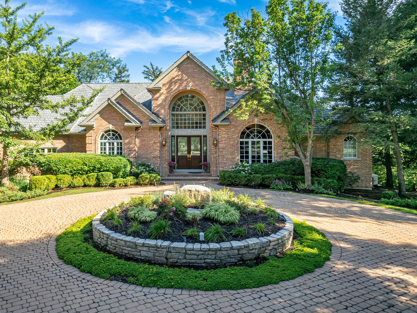 Fantastic Wynstone Ranch - This home is a masterpiece of design, offering an unparalleled vantage point overlooking Jack Nicklaus' Signature 3rd Golf Hole that marries architectural sophistication with an open, airy floor plan designed specifically for grand-scale entertaining and quiet relaxation alike. Inside, the residence is defined by soaring palladium windows that act as living canvases, capturing magnificent sunlight and the vibrant colors of the surrounding landscape. The heart of the home is the expansive Great Room, a versatile space featuring a custom bar and distinct areas for media, dining, and intimate conversation. For more focused moments, the handsome custom-paneled office provides a refined retreat, complete with its own fireplace. Culinary enthusiasts will gravitate toward the recently renovated kitchen, a high-end workspace equipped with Sub-Zero and JennAire appliances that flow seamlessly into the main living areas.  The primary suite is a sanctuary of its own, boasting custom built-in cabinetry, two spacious walk-in closets, and a spa-inspired bath and french doors to a private deck, where you can begin your morning with serene, elevated views. Guests will enjoy their own dedicated wing, which houses three well-appointed bedrooms and 2 additional baths, ensuring privacy for everyone.  Every corner of this home is curated for comfort. Enjoy the cozy four-season room with fireplace that allows you to enjoy the beauty of the outdoors year-round. Fiinished English basement, a massive footprint for recreation with dedicated spaces for billiards, exercise, and play along with full bath and loads of storage space.  Outside, a spacious paver patio offers an unforgettable backdrop for sunset gatherings overlooking stunning landscape and golf course.   Complete with a four-car side entry garage and a grand circular drive, this estate represents the pinnacle of luxury living in North Barrington.