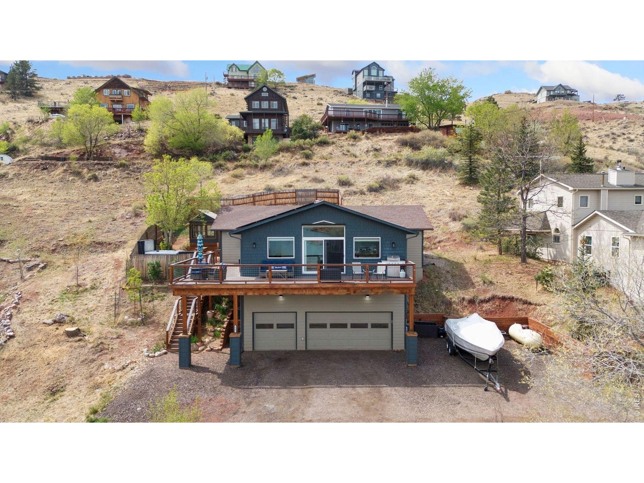 Experience Colorado living at its finest in this beautifully updated raised ranch, perfectly positioned to capture breathtaking views of Horsetooth Reservoir. Offering 3 bedrooms, 2 bathrooms, and just over 2,000 square feet, this home blends comfort, style, and functionality on a spacious .35-acre lot. Step inside to find thoughtful updates throughout, creating a warm and inviting atmosphere ideal for both everyday living and entertaining. The open layout flows seamlessly to a stunning wraparound deck-perfect for soaking in the views, enjoying morning coffee, or hosting sunset gatherings. Designed with the Colorado lifestyle in mind, the property features a 3-car garage complete with epoxy floors and overhead storage-plenty of space for all your lake and mountain gear. Outside, you'll find a charming garden she-shed, a relaxing hot tub, and ample room to enjoy the outdoors. Additional highlights include a tankless hot water heater and solar, offering energy efficiency and long-term savings. Whether you're looking for adventure or tranquility, this property delivers the perfect balance-just minutes from Horsetooth Reservoir, yet offering privacy, space, and unforgettable views.