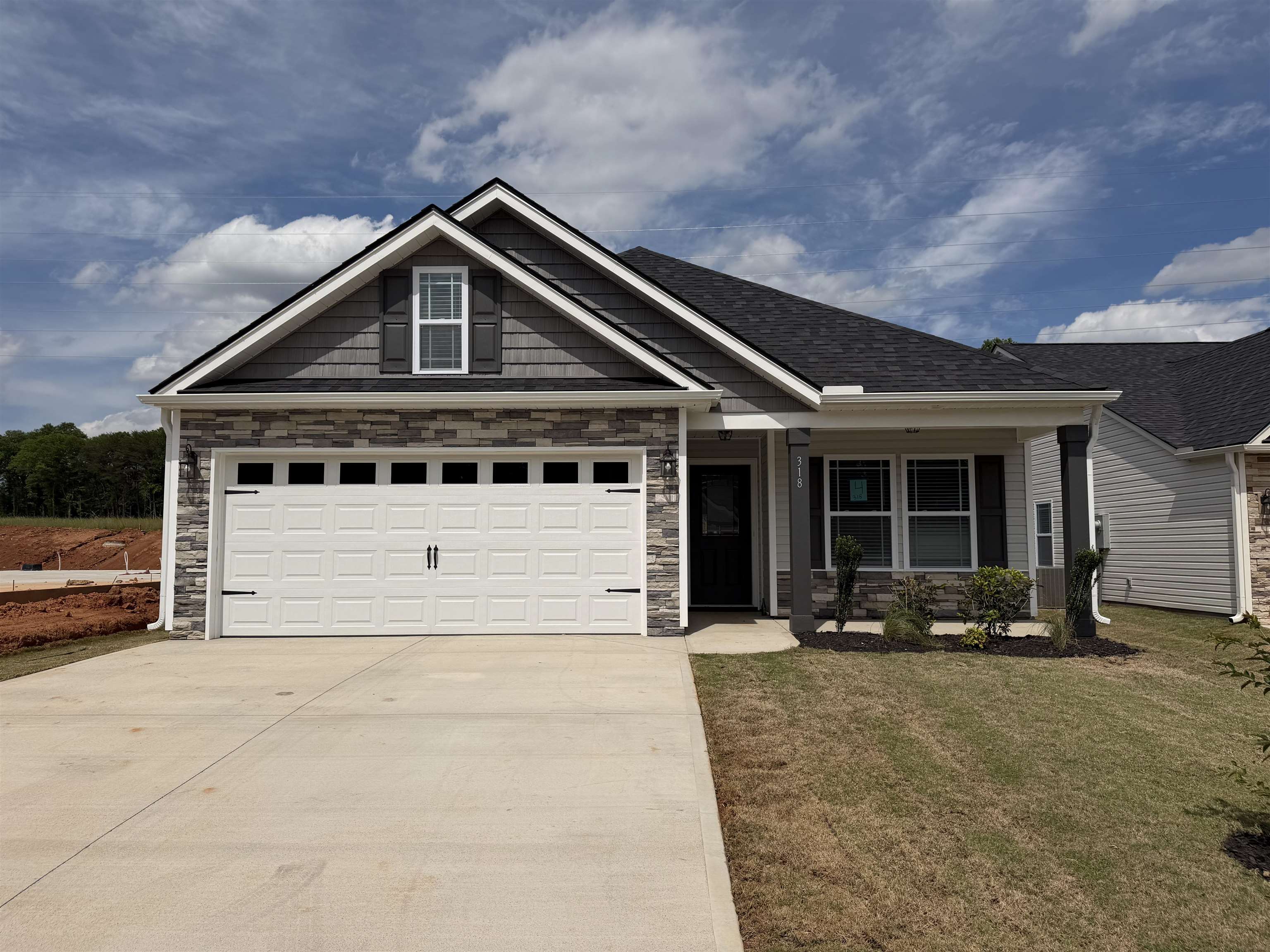 MOVE IN READY new construction in the desirable Stones Throw community featuring the popular Cheshire plan. This well-designed one-story home offers 4 bedrooms and 2.5 bathrooms with a functional, open layout ideal for everyday living. Spacious living area flows into the kitchen and dining space, perfect for entertaining or gatherings. Private primary suite with ensuite bath, plus three additional bedrooms providing flexibility for guests, home office, etc. Attached 2-car garage for added convenience. Located in growing Inman, SC, with easy access to shopping, dining, and major highways. Quality construction and thoughtful design make this home a must-see. Ask about the Closing costs incentive offered when using preferred lender and attorney! Call today for more info!