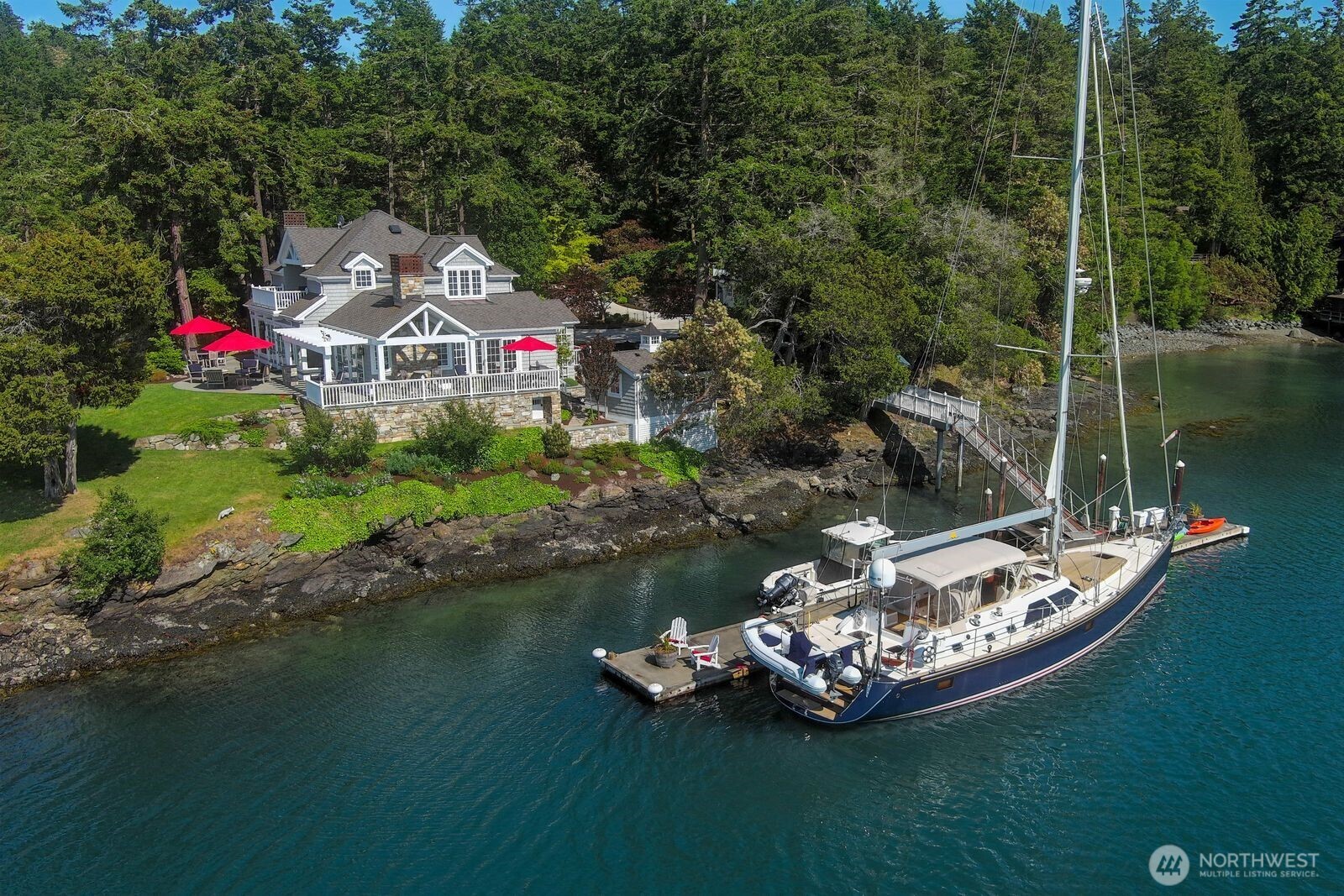 This stunning estate on San Juan Island can be accessed by boat or seaplane via a private 100-foot year-round deep water dock. The entire 1.21 ac estate has been fully remodeled with meticulous craftsmanship in the main home, guest house, bunk house, barn and garden. The 3800 sqft home features a spacious, light-filled open floor plan and high ceilings. The living room, chef's kitchen, study, sunroom, and main ensuite bedroom all overlook the sea. A second parcel includes a barn with storage and a fenced garden. With ample space for outdoor entertaining, this property is perfect from sunrise to sunset. A delight for boaters and seaplane owners, featuring a dock, mooring buoy, and 578 feet of waterfront for you and your guests to enjoy.