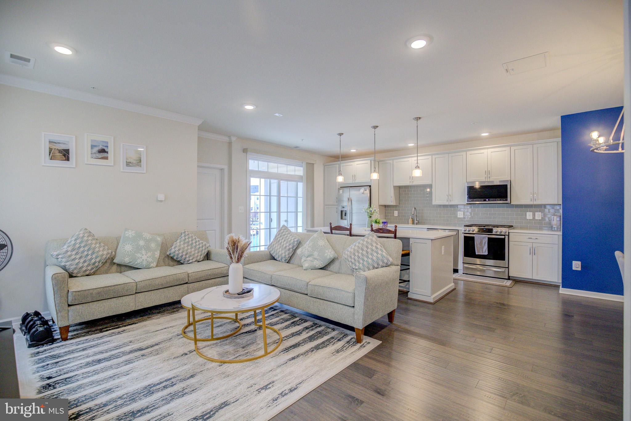 Welcome to this Luxury Garage Townhome style Condo so light & bright with a Southern exposure!  You will delight with the Elegance and Conveniences in this contemporary 3-Level home with no unit above or below.  Features include:  3 bedrooms, 2.5 baths, with Gleaming Hardwood Floors on the main level and foyer.  The Open-Concept main level, with 9 ft. ceilings, recessed lighting, and crown molding, contributes to a stunning Gourmet Kitchen which includes a large center island, pendant lighting, granite countertops, subway tile backsplash, stainless steel appliances, & a gas range.  The kitchen is open to a formal dining space and great room that is perfect for relaxing or entertaining family & friends with a convenient balcony and half-bath.  The main level has a desirable Bonus Room off the living area that can be used as a home office or third bedroom!  The upper level features a spacious primary bedroom with a walk-in closet and a private ensuite bath with a double-vanity and granite countertop.  The well-sized secondary bedroom also has its own private en-suite bathroom.  The laundry is located on the upper level for your convenience.   Excellent parking too as it offers an attached Garage complete with an EV Charging Station and has an additional long, private driveway for added ease and convenience.  The community offers a wide range of amenities including:  3 clubhouses with pools, tennis/pickleball, volleyball, & basketball courts, fitness centers, yoga studio, tot lots, walking/biking trails, & outdoor grilling areas.  Great location convenient to restaurants, shopping major commuter routes, metro, and schools.  Close to Brambleton Town Center, Park & Ride, Silverline Metro, Routes 28, 29, 50, Loudoun Co. Pkwy., and Dulles Toll Rd.  Just move-in and enjoy modern living at its finest at the Ridges at Loudoun Valley!