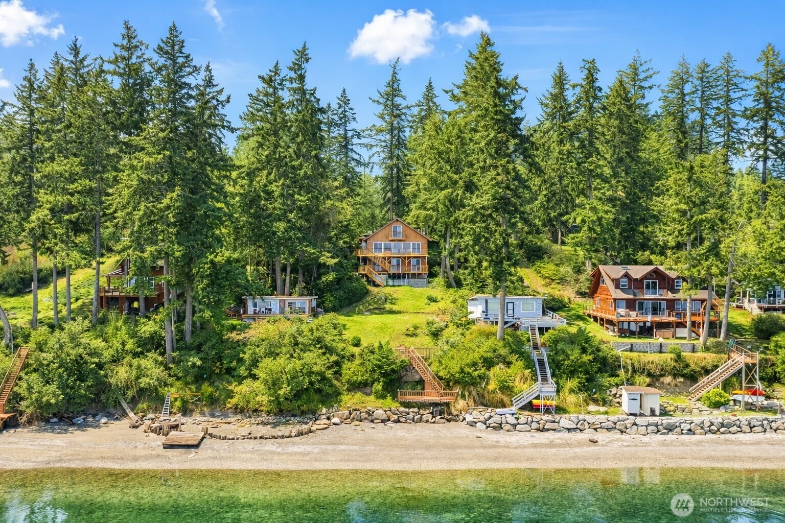 Welcome to the ultimate waterfront retreat! Immerse yourself within this tranquil island setting that lives as if in a writer’s storybook yet is a picturesque 15 minute ferry ride from the Key Peninsula with all of the creature comforts. Enjoy the large open style kitchen with great room  and a wall of windows taking in 180 degrees of sound views, fresh interior paint, new flooring and new septic system. Featuring views from all rooms this 3 bedroom home also offers an upper loft-style sleeping area, perfect for hosting extra guests! Sporting 2 large covered entertaining decks as well as a third deck area just steps to the beach, here you will capture all of the enjoyment from the sandy 60 feet of glorious waterfront with mooring buoy option.  Herron Island amenities include a dedicated ferry, community beach access, dock, boat-launch, playground and trails, all with a close-knit community atmosphere. Within walking distance from the ferry this home offers the serenity of island life without sacrificing convenience. A rare opportunity to enjoy quiet coastal living—don’t miss it!